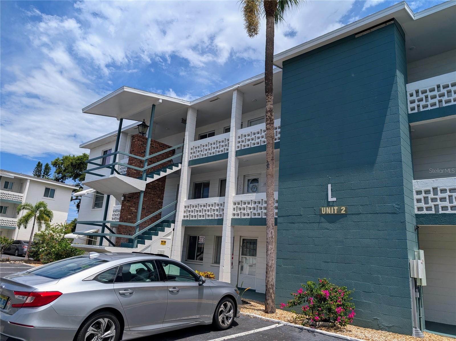 WOW... Have you been wishing, wishing for a cost-effective winter or full-time place? Not too late! Look at this price! Pretty 2BR/2BA located on 2rd floor. Attractive flooring. Updated kitchen and appliances. Tranquil screened lanai. Clean, tidy, well-organized. It's turnkey furnished, PLUS has a laundry room complete with washer/dryer already installed. Elevator in center and stairs at either end of building. Heated pool! Clubhouse! Spotless large laundry!Activities! 55+ community. Low HOA & condo could be rented after owning 1yr. NO pets. NO smoking. Close to public bus stop and only a block from Bayshore Shopping Center w/Publix, Target, TJMaxx, banks, stores, places to eat. Interested? Now is the time, do not wait...