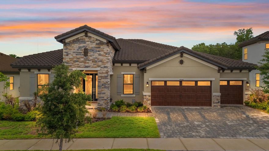 Welcome to the resort-style Hinton Hawkstone community, where this stunning 2023 executive home is move-in ready, with no rear neighbors. This spacious 4-bedroom, 3-bathroom home also includes a private office and a large bonus room, providing flexibility for everyday living or entertaining. From the curb, the home stands out with its tile roof, elegant archways, and pavered driveway leading to a 3-car garage. Inside, you’re greeted by a formal living area and a dedicated office before stepping into the open-concept great room, designed for both comfort and functionality. Throughout the home, you’ll find carefully selected upgrades, cohesive color tones, and stylish finishes that truly shine in person. The primary suite offers a private retreat with a generous walk-in closet and a spa-inspired bathroom featuring dual granite vanities, a soaking tub, and a walk-in shower. The split-bedroom layout provides added privacy, while the versatile bonus room, currently used as a fitness and play space, can easily be converted into a media room, game room, or additional living area, with direct access to the backyard. Additional features include ample storage, an indoor laundry room, and a covered patio that’s pre-wired and plumbed for an outdoor kitchen ideal for creating your perfect outdoor entertaining space. Enjoy the peaceful, tree-lined backyard with no rear neighbors for added privacy. Smart home features such as a security system, whole-home speaker system, and smart thermostat add convenience and modern appeal. Residents of Hinton Hawkstone enjoy access to resort-style amenities, including a lagoon pool with splash pad, lap pool, pickleball courts, playground, dog park, and more, all conveniently located near top-rated Lithia schools.