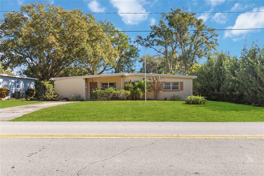 Situated just minutes from downtown Orlando, Orlando International Airport, and major highways, this centrally located 3-bedroom single-family home offers convenience, flexibility, and no HOA restrictions. Built with solid block construction and set on a 0.19-acre lot, the property features laminate, vinyl, and tile flooring throughout, creating a low-maintenance living environment. Major system updates include the roof, HVAC, plumbing, and electrical, providing peace of mind for the next owner. The primary bedroom includes an en-suite bath and connects to a hallway half bath, while an additional ADA-compliant half bath is located off the bonus room with laundry. The bonus room features a separate exterior entrance, making it ideal for a home office, guest space, or flex room. The kitchen opens to a screened-in porch overlooking a private, fenced, tree-lined backyard—perfect for entertaining or relaxing. A large 18x15 shed with a 10-foot roll-up door offers ample storage or workshop potential. With proximity to shopping, dining, entertainment, theme parks, and major employment corridors, this home presents a strong opportunity for owner-occupants, investors, or anyone seeking a centrally located Orlando residence with versatility and long-term value.