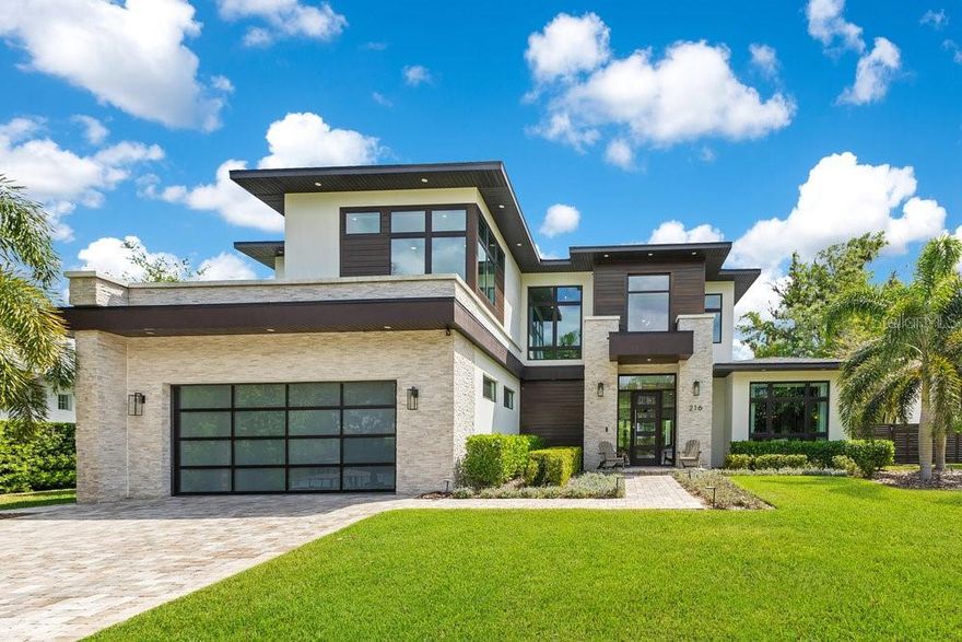 Exquisite Lakeview pool home, built in 2021, combines modern elegance and timeless style. Located in the heart of Maitland, with front-row seats to unforgettable sunsets over Lake Sybelia! This Five bedroom, Five and a half bath residence boasts 4,697 square feet of tastefully designed living space. Inside you’re met by a grand foyer and airy layout flooded with natural light, soaring ceilings, wide-plank hardwood floors, custom window treatments, and designer finishes throughout.
The gourmet kitchen is an entertainer's delight-equipped with top-of-the-line Wolf and Sub-zero appliances, Taj Mahal quartzite, stunning 12-foot waterfall island, 48” 8 burner gas range with pot filler, large walk-in pantry, with butler’s pantry adjoining the kitchen and dining— the open concept design is perfect for both entertaining and every day living. The living room’s quartz-accented fireplace and sleek glass folding doors provide a seamless flow between indoor and outdoor living. Retreat to the primary suite's spa-inspired bathroom with custom designed walk-in closet, dual vanities, soaking tub and double walk-through shower. A sleek cable railing staircase leads to four generously sized Bedrooms-three with ensuite baths, four bathrooms, a designated Office and versatile Loft/Flex space. Enjoy breathtaking lake views whether working or unwinding! Equally impressive is the beautifully landscaped outdoor living space, with expansive covered lanai, multiple lounge areas, fully equipped summer kitchen, gas fire pit and luxurious salt-water pool and spa. Property features smart home technology, custom closets systems, remote controlled window treatments, surround sound, full-house generator, 500 lb propane tank, 3 car garage with epoxy flooring and so much more! A short walk to Lake Lily and the Maitland Farmers Market, and minutes to Winter Park and I-4.  This exceptional home combines refined luxury with an unbeatable location. Don’t miss out on this rare find!