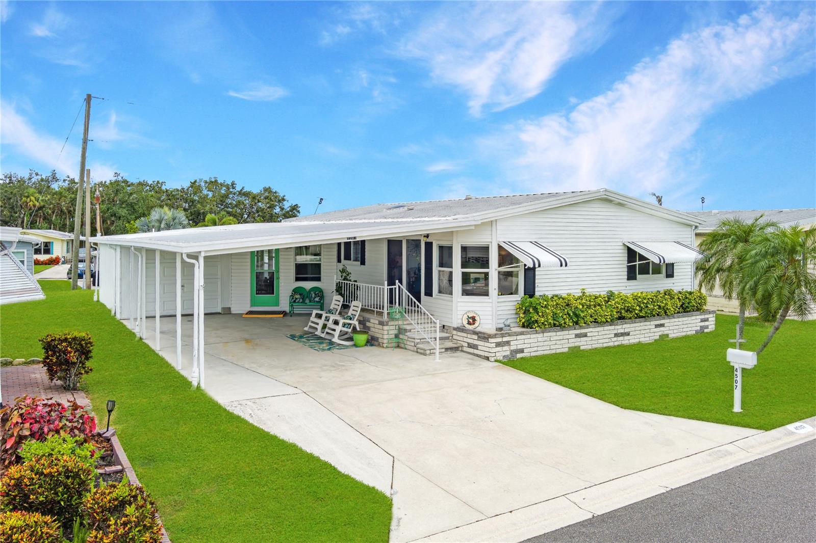 Welcome to this charming 2-bedroom, 2-bathroom home that offers comfort, functionality, and classic Florida living. The spacious primary suite features a walk-in closet and a private ensuite bathroom with a walk-in shower, providing the perfect retreat at the end of the day.
The bright and inviting living room is filled with natural light thanks to large sliding glass doors that overlook the outdoor space, creating a cheerful, open feel throughout the home.
The kitchen offers plenty of room for cooking and storage, along with a convenient eat-in dining area perfect for casual meals or entertaining guests.
One of the highlights of this home is the Florida room, a versatile space that can be air-conditioned for year-round comfort or opened up to enjoy the amazing cross breeze. It’s the perfect spot to relax, unwind, or simply enjoy the peaceful surroundings.
Step outside and you’ll find a nice-sized backyard where you can soak up the beautiful Florida weather. Whether you enjoy gardening, grilling, or simply relaxing outdoors, this backyard offers space to make it your own.
The home also features a durable metal roof, a one-car garage perfect for storing a golf cart, compact car, or SUV, and a roomy carport that can accommodate two additional vehicles or be transformed into a shaded seating area.
Located in a lovely, well-maintained park, this home is just minutes from restaurants, shopping, and all the conveniences you need. Don’t miss the opportunity to make this affordable Florida lifestyle yours!