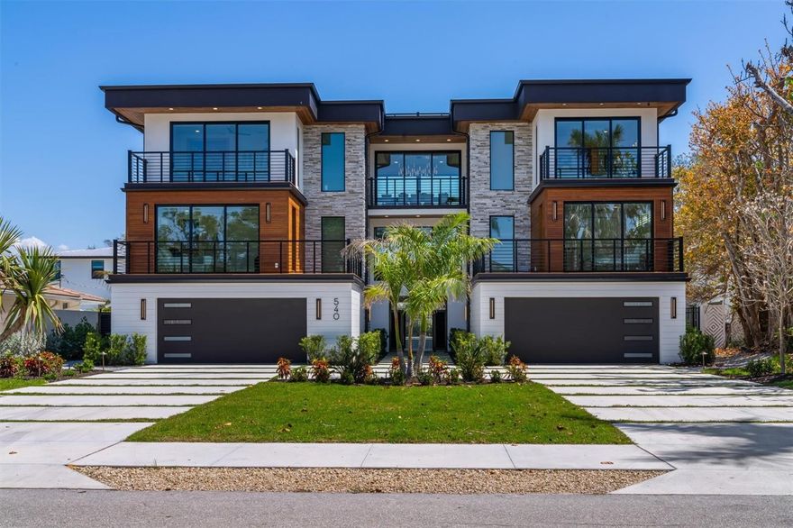 This exquisite residence offers a sophisticated contemporary design spanning 9,258 square feet of resort-style living, ideally situated steps from beautiful Gulf beaches. The interior living space encompasses 5,331 square feet, meticulously appointed with bespoke finishes. The home comes fully furnished with a curated collection of premium furniture. The gourmet kitchen is centered around a spacious island with a waterfall countertop and equipped with luxury appliances such as a Sub-Zero refrigerator and a Wolf eight-burner gas range, complemented by dual dishwashers. Floating shelves, European-styled cabinetry, enhance aesthetics and functionality. Sophisticated interior design elements are evident throughout, including quartz countertops, an interior elevator and designer lighting. Custom tambour wood walls, artisanal iron stair rails, 7-inch baseboards and 8-foot interior doors contribute to the home's refined character. Each floor features a wet bar with beverage refrigerators, ice makers or dishwashers for effortless entertaining. The primary suite provides a private retreat with walk-in closets and an en-suite bath featuring a backlit marble wall and designer fixtures, including a walk-in shower with rain and handheld showerheads. Five additional bedrooms each include uniquely designed en-suite baths with designer plumbing, custom mirrors, distinctive shower designs, sleek cabinetry and under-lighted vanities. The incredible outdoor living spaces comprise over 3,300 square feet, featuring multiple covered patios and six balconies, culminating in a rooftop deck with 360-degree views of the gulf, bay and city. The summer kitchen offers a Heston Aspire grill and a wet bar. The ground level offers both dry and wet bar entertaining areas, each with large-screen TVs. The fenced backyard is a tropical oasis with a heated, saltwater pool, waterfall and fiber optic lighting, alongside a 12-person heated spa. A private putting green caters to golf enthusiasts. Various outdoor entertaining areas provide options for dining, sunbathing, and games like pool or ping pong, complete with additional TVs and beverage refrigerators. The property integrates advanced security and technology, including a comprehensive integrated surveillance system with high-definition cameras. A whole-property Wi-Fi network ensures seamless connectivity. Intelligent access control systems offer keyless entry and remote management. Programmable architectural lighting and motorized window treatments allow for personalized ambiance and efficiency. A Sonos multi-room audio system provides integrated entertainment, complemented by 12 strategically placed high-definition TVs and multi-zone surround sound. Architectural and structural highlights include an exterior with stacked stone and wood cladding, balconies with horizontal rails, and Ipe wood flooring on balconies and rooftop deck. The residence is equipped with hurricane-rated windows and doors. Exterior and landscape lighting create an inviting ambiance, while outdoor spaces are finished with tongue and groove wood ceilings and travertine pavers. This property is ideally in short distance to pristine Gulf beaches and offers proximity to shops and restaurants of St. Armands Circle. It is zoned for short-term rentals (minimum seven days) and is just 10 minutes from downtown Sarasota's arts, dining and entertainment, with top-rated private yacht, and golf and country clubs nearby.