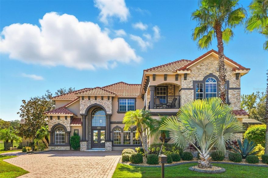 Welcome to this SPECTACULAR RENOVATED LUXURY RESIDENCE located in the exclusive gated community of PROVIDENCE in Davenport, Florida!!! Nestled on a private cul-de-sac lot with stunning lake and golf views, this 6-bedroom, 5-bathroom home with a game room, private office, and resort-style outdoor area offers the perfect blend of sophistication and comfort.

As you enter through the elegant double front doors, you’ll be greeted by cathedral ceilings, modern stone wall accents, and a beautiful porcelain staircase that sets the tone for the entire home. The formal dining room features an inviting electric fireplace, ideal for memorable family dinners. The formal living area opens to the backyard through sliding glass doors, perfect for enjoying peaceful afternoons or breathtaking sunrises.

The kitchen and family room combination is the heart of the home — featuring panoramic windows, a warm wood-burning fireplace, and luxury finishes throughout. The private office includes custom built-in shelves and cabinetry, providing a quiet space to work from home.

The luxurious primary suite, conveniently located on the first floor, offers privacy and comfort with spa-inspired details. Upstairs, you’ll find five spacious bedrooms, each with great views of the golf course and community, along with a game room perfect for movie nights or family fun.

Step outside to your private screened oasis, complete with an extended lanai, outdoor kitchen featuring Paradise Grill appliances, and a sparkling pool — ideal for entertaining or simply relaxing in your own retreat.
The home’s heating and cooling systems are connected to FULLY PAID SOLAR PANELS, providing energy efficiency and lower utility costs year-round.

Providence is one of the most sought-after luxury communities in Central Florida, offering 24-hour guarded entry, an on-site restaurant, championship golf course, and resort-style amenities with LOW HOA fees and NO CDD.

Experience the lifestyle you deserve — this home truly has it all!