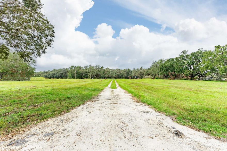 What does your honey want? 4.9 ACRES for sale in the majestic land of Webster. Set your eyes upon the lush grass fields of this 4.9 acre parcel.  Flat land is ready for you to view and plan your custom home. Set against the pond, your new home will amaze all the neighbors. Located on site, already installed for ease of mind: electric pole with 200 amp service-hooked up with SECO. AND ..AND we already have the well in place. Fence is located on three sides, too.  Now that all your boxes are checked - put in your offer.