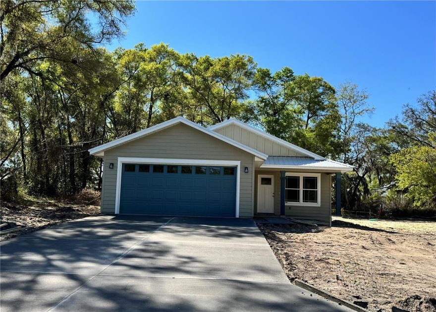 One or more photo(s) has been virtually staged. Under Construction. One or more photo(s) has been virtually staged. Pictures are of a prior completed model. Estimated completion date mid March 2026. This bright & open floor plan sits on a spacious .23 acre lot located 5 minutes from downtown Newberry with the benefit of the low Gilchrist County taxes. The home features step up tray ceilings in the great room & master suite, a spacious kitchen island, energy efficient appliances & raised panel custom wood cabinets. Doors off of the kitchen lead to a covered patio - perfect for entertaining and indoor/outdoor living. The luxury master suite boasts an inviting bathroom w/double vanities, European style shower & oversized walk-in closet. There is no shortage of storage in this home including a spacious laundry room for all of your organizational needs! Home features 2-car garage. The layout of the virtually staged photos may not necessarily match the layout of this lot - please visit site to see lot and home details.