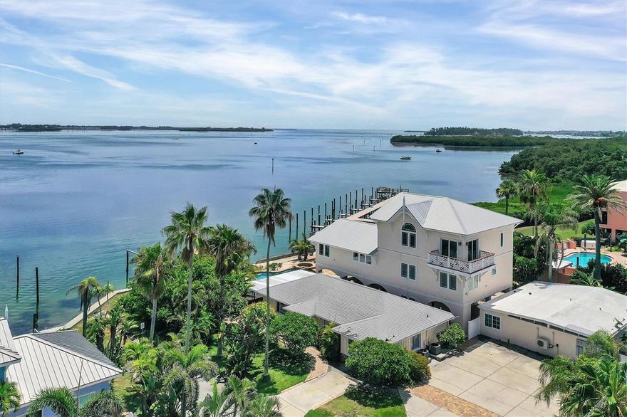 Bayfront Estate perfect for an island get away, a family compound, or VRBO investment property.  This unique waterfront complex directly on Sarasota Bay with views of the Sarasota skyline & AMI beach.  Property consists of the main house (4 bedrooms & studio apt), a cottage (2 bedrooms), and duplex (2 bedrooms).  Main house has been remodeled by prior owners to hurricane specs, and custom features consisting of granite and marble counters with back splashes, teak flooring, and has an elevator to all floors.  There is an 800 SF deck overlooking the Bay and a deck off one of the bedrooms, which overlooks the Gulf of Mexico.  The ground floor 2 bd/2 bth cottage has a spacious covered lanai with Bay views, great room, and kitchen.  The ground floor duplex has 1 bd/1 bth, and kitchenette in each.  These two separate structures are perfect for mother-in-law suite, guests, staff, office, or rentals.  This estate also has a large fitness room overlooking the Bay.  The property sits at the end of a short, very private, quiet street which is only a half block to the pristine water of the Gulf of Mexico.  Includes a lagoon style heated pool & hot tub facing the Bay.  There are two deep water wood docks with electric and water supply.  Enjoy magical sunrises and sunsets from this stunning setting all year round!
Serious inquiries only please.