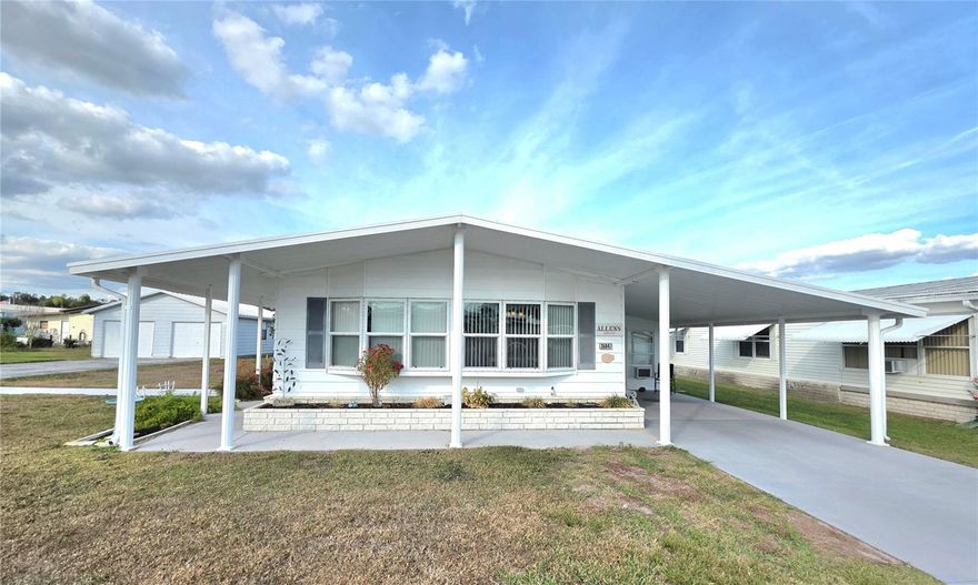 What a fabulous place to call home! This charming, turnkey, fully furnished, Two-bedroom, Two-bathroom home has been lovingly maintained, and pride of ownership shows. A welcoming street level Florida room greets you and includes tile flooring, wall mounted air conditioner, ceiling fan, attached utility room with work bench, shelving for storage & provides convenient egress to the large back yard with paver patio & freestanding golf cart building. As you enter into the home there is a nice eat-in or office space with closet and a beautifully updated galley style kitchen with Oak cabinetry & newer appliances. Just off the kitchen is the formal dining area which boasts a bay window, cathedral ceiling, custom Oak hutch with title countertop & glass front cabinet doors. The living room is open to the dining area and also features a cathedral ceiling and bay window which gives a nice spacious feel to the room. Just down the hallway is a dedicated laundry room with front loading washer and dryer, built in folding area with cabinets above & built-in coat closet. Just next to the laundry room is the updated main bathroom its features include a built-in linen closet, Oak vanity cabinet, vinyl tile flooring, fiberglass tub with shower surround & etched sliding glass shower door with dolphin motif. Conveniently located across from the main bathroom is the guest bedroom where you will find dual closets that provide additional storage space for you or your guests. Located at the back of the home is the private feeling primary bedroom suite, this spacious room features a cathedral ceiling with fan, a large walk-in closet with mirrored doors, and an updated en-suite bathroom with Oak vanity cabinet, dual sinks and a walk-in shower with sliding glass doors. This Beautiful home is being sold completely furnished including all major appliances. Situated in Betmar Acres, one of Florida's most sought-after 55+ communities where you own your land—no lot rent required. With annual park dues of only $448.00, it's an appealing choice for those seeking an active lifestyle in the Sunshine State. Why spend your winters cold & snowed in when you could be enjoying all that Betmar Acres has to keep you busy, from Bingo and shuffleboard to swimming in the heated pools, unwinding in the two hot tubs, playing golf, or engaging in a game of pickleball. This community has everything you need to keep you entertained and it's in a great central Florida location close to hospitals, shopping, restaurants and only an hour away from theme parks and beautiful award-winning gulf beaches. Plan your visit today!