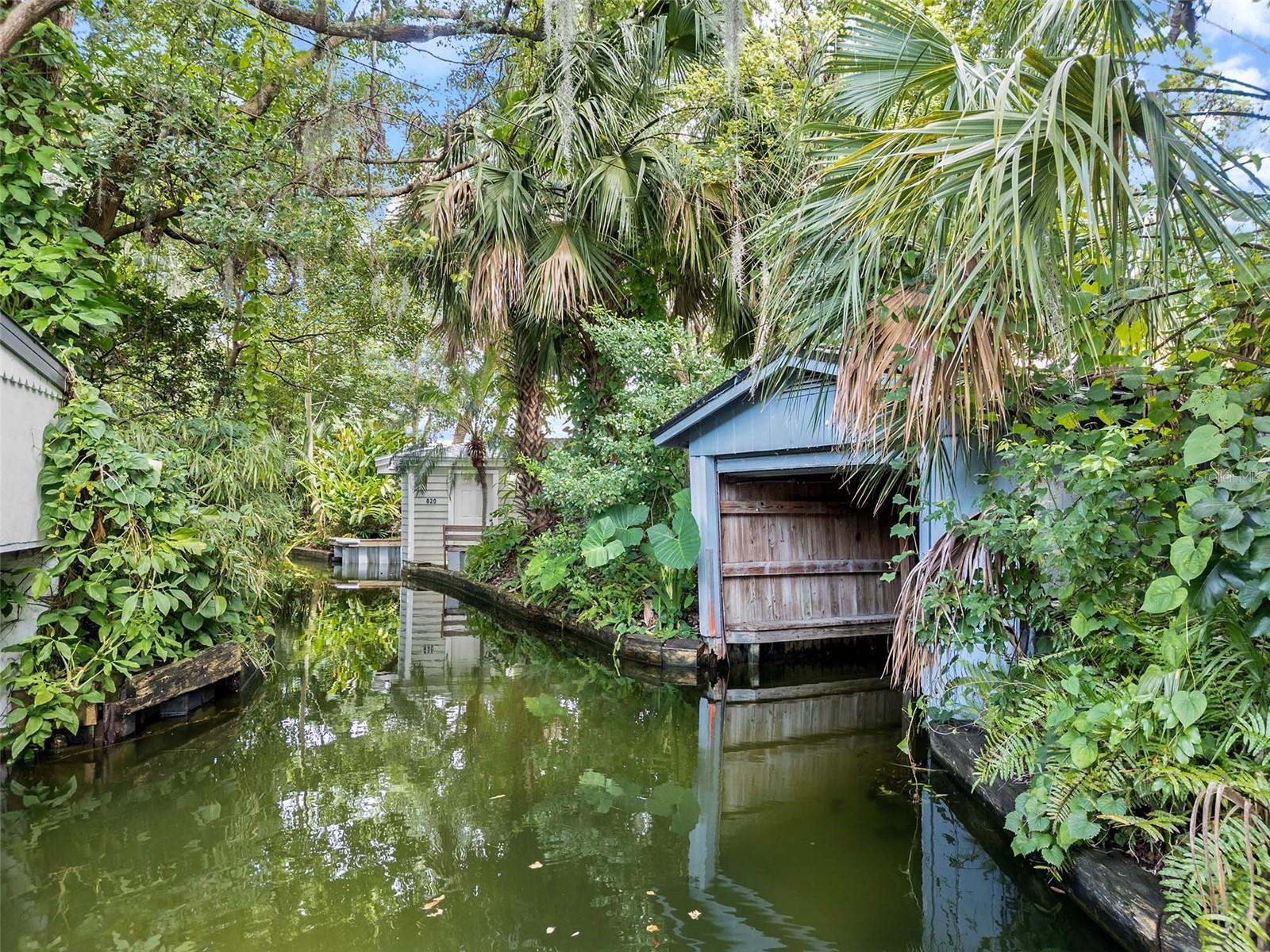 825 Palmer Avenue, Winter Park | $1,799,000 - A Rare Venetian Canal Treasure Awaits Your Vision! Discover an extraordinary opportunity on one of Winter Park's most coveted waterways. This exceptional single-story estate on Palmer Avenue presents over 3,200 square feet of pure potential, perfectly positioned on an oversized .35-acre lot (85x173') with exclusive boathouse access to the prestigious Venetian Canal and Winter Park Chain of Lakes. Steps from the sophisticated boutiques and world-class dining of Park Avenue, this rare find offers the ultimate Winter Park lifestyle where luxury meets convenience. The thoughtfully designed open floorplan showcases expansive living spaces flooded with natural light from strategically placed skylights. Rich hardwood floors flow throughout, while French doors create seamless indoor-outdoor living. The dramatic great room captivates with distinctive brick flooring, copper-coated ceiling tiles, and an old-fashioned built-in bar—perfect for entertaining. The generously proportioned primary suite features an en suite with double sink vanity and walk-in shower. Two additional well-appointed bedrooms, each with full baths, provide comfort and privacy for the family and guests. The heart of the home centers on an expansive gourmet kitchen boasting dual sinks, premium stainless-steel appliances, solid wood cabinetry, and distinctive decorative tile countertops. A dedicated home office provides the perfect work-from-home sanctuary. Two inviting fireplaces create cozy gathering spaces throughout. The covered patio with ceiling fans extends living space outdoors, while the screened pool area offers private resort-style relaxation. The tile roof crowns this impressive estate with both beauty and durability. Whether you envision a stunning renovation showcasing the home's exceptional bones or a complete rebuild taking advantage of the prime waterfront location, this property represents a once-in-a-lifetime opportunity to create your Winter Park masterpiece.