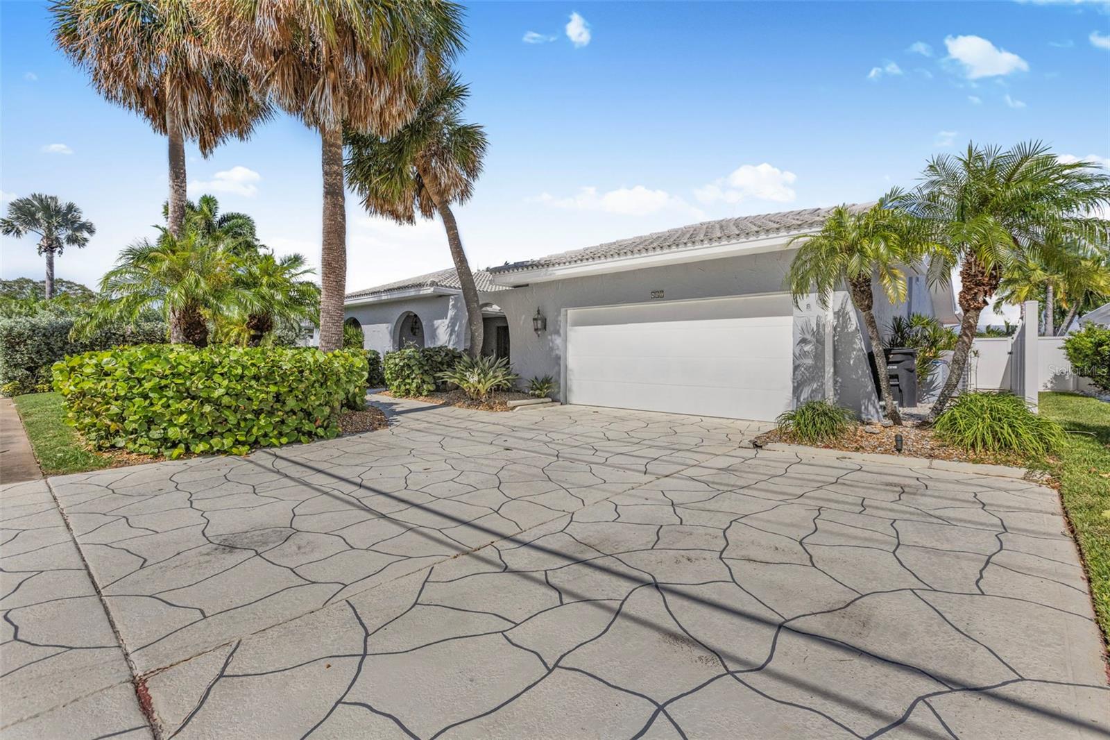 Tropical waterfront living at its finest—this spacious Island Estates home offers stunning, unobstructed views straight down the channel. With privacy landscaping on both sides and no flooding from recent hurricanes, you’ll enjoy peace of mind and postcard-worthy scenery from your Great Room, Kitchen, and Primary Suite.
Just under 3,000 square feet, this 3-bedroom, 2.5-bath home has plenty of room to spread out. The kitchen features granite countertops and rich wood cabinetry, while the oversized Great Room comes loaded with built-ins. The full-size laundry room includes a Maytag Centennial washer and dryer, and the 2-car garage has an epoxy floor, overhead storage, and a wide driveway perfect for guests.
Step outside to a beautifully manicured lawn with palm trees and tropical shrubbery. The large pool deck surrounds a saltwater pool and outdoor shower, just steps from your private dock and boat slip—ideal for a vessel up to 30 feet. The newer vinyl fencing wraps the property for added privacy.
This home is built for comfort and protection, with a high-efficiency Carrier HVAC system (2018), Anderson windows and sliding glass doors, electric roll-down storm shutters, impact-rated accordion shutters, and Lexon translucent covers for side windows. It also includes a built-in speaker system, ADT wireless fire and smoke monitoring, Whirlpool water softener, and ProSystems filtration.
Island Estates is one of Clearwater’s most sought-after boating communities, known for its deep channels and unbeatable location. You’ll be within walking distance of Publix, restaurants, a UPS store, and even the Clearwater Marine Aquarium. Clearwater Beach is just minutes away by bike, car, or the Jolley Trolley.
This is a rare opportunity to own a large, storm-resilient waterfront home in a prime location—offered at a very attractive price in today’s market. Don’t wait to schedule your showing.