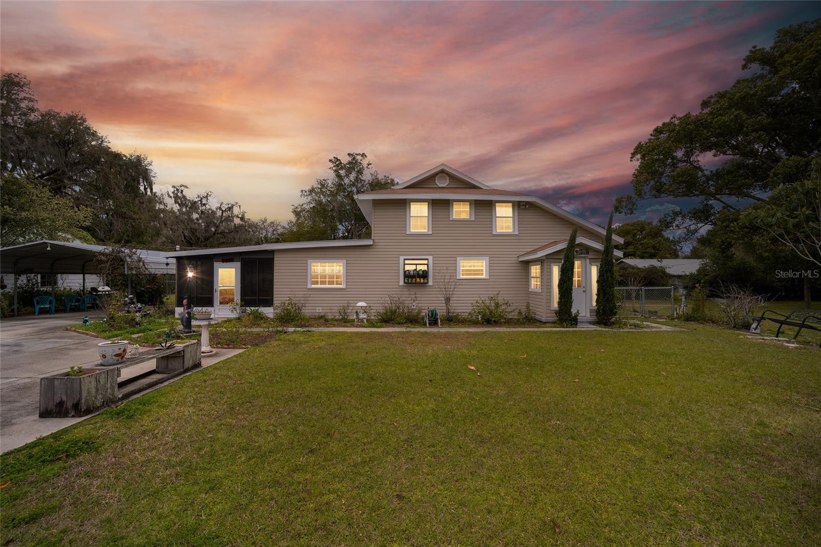 This well-cared-for and charming historic home offers a perfect blend of comfort and convenience with a fantastic location just steps away from Lake Lillian, offering an abundance of outdoor activities. The welcoming foyer, filled with natural light, leads to inviting living areas, including a well-equipped eat-in kitchen with a pass-through overlooking the warm and inviting knotty pine-accented living room. Additionally, there's a spacious 12x20 Florida room, ideal for both entertaining and unwinding for a wonderful blend of comfort and functionality. Private upper-level Owner's Suite with hardwood flooring and en suite bath with a double sink vanity and tile-lined backsplash. Special features include security lighting, two sheds for storage needs, double carport, 2 water meters (1 for outside irrigation system), a new roof and A/C in 2014, and a downstairs guest bedroom. Conveniently close to shopping, dining, and the Community Park amenities which include a serene lake with a dock, a playground, a 3/4-mile paved walking trail, a 1-mile dirt fitness trail, multiple mini pavilions, and a spacious pavilion featuring picnic tables and a stage.