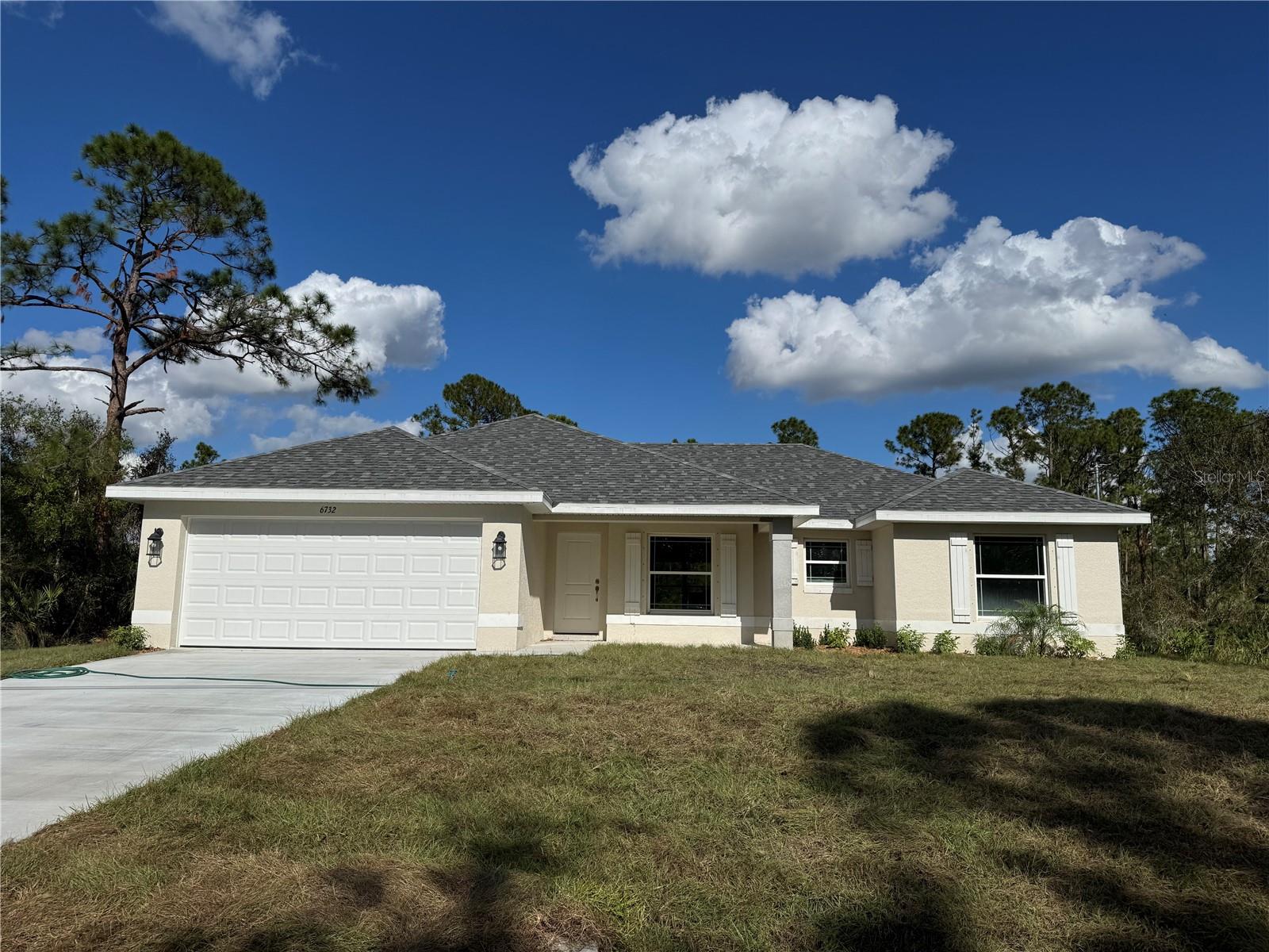 Welcome to your new home in beautiful North Port, Florida! This charming 3-bedroom, 2-bathroom residence with a 2-car garage offers a perfect blend of comfort and style, situated in a vibrant community known for its wonderful amenities and attractions. Designed for privacy and convenience, this split floor plan is perfect for families and guests. The spacious living room, with its vaulted ceilings, enhances the open, airy feel of the home. Ceramic tile flooring runs throughout, with plush carpet in the bedrooms providing a cozy touch. The primary bedroom is a highlight, featuring double vanities with granite tops, a walk-in closet, and an garden tub with a separate, walk-in shower. The kitchen is well-equipped with stainless steel appliances, including a range, microwave, dishwasher and granite countertops. Quality fixtures such as brushed nickel Moen faucets, LED lighting, and 5-panel doors add a touch of elegance to the home. Efficiency is a key feature, with double pane tilt-in windows ensuring easy cleaning and lower utility costs. Additional features include 5 1/4" baseboards, upgraded painted cabinets, and a built-in pest defense system. The exterior of the home boasts a professional landscaping package, adding curb appeal and ease of maintenance. The property is on city water, providing reliable and convenient service. The builder offers a comprehensive warranty package, including a 1 Year Workmanship, 2 Year Systems, and 10 Year Structural Warranty for peace of mind. Most closing costs are covered with an approved lender, making your move even easier. You can secure this home with only a $1,000 deposit, and the pricing includes the lot. North Port is a thriving community with a wide array of attractions and amenities. Enjoy outdoor recreation in nearby parks, golf courses, and the Warm Mineral Springs. There is convenient access to local shops, restaurants, and cafes, and some of Florida’s best Gulf Coast beaches are just a short drive away. This area boasts excellent schools, community centers, and numerous activities for all ages. Additionally, you’ll be close to top-notch medical facilities and services. Don’t miss the chance to own this incredible home in one of Florida’s most desirable, growing communities. Schedule a viewing today and make this North Port gem your own!