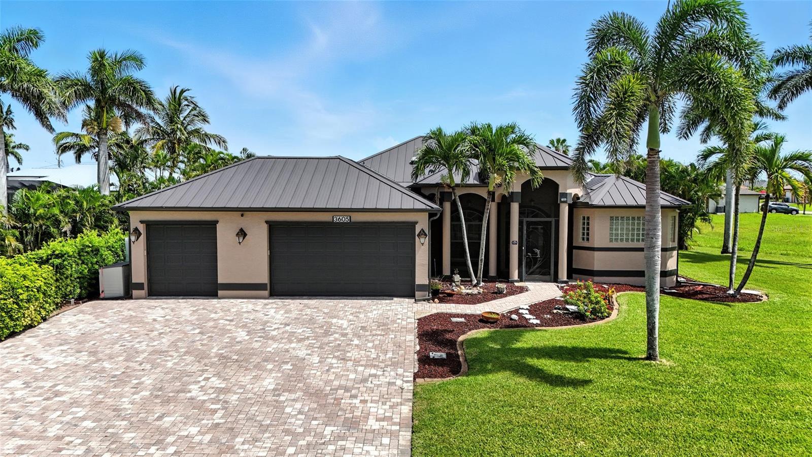This spacious 4-bedroom + den, 3-bathroom home offers the perfect blend of comfort, style, and waterfront living. With 2,147 sq ft under air, this thoughtfully designed split-bedroom floor plan ensures both privacy and openness—ideal for entertaining or everyday family life. Enjoy tranquil water views from both the front and back of the home, setting the tone for relaxed, coastal living. Boaters will appreciate the direct Gulf access via boat lift (10,000 lb capacity, with bridge access), an expanded dock with shade, and a spa to unwind after a day on the water. Step inside to a light-filled interior featuring tile and carpet flooring, volume ceilings, and an inviting open concept. The kitchen includes new stainless steel appliances, an eat-in area, and a breakfast bar that flows seamlessly into the living and dining spaces. The primary suite is a private retreat with a 2022-upgraded bathroom, dual sinks, soaking tub, and walk-in shower. Additional upgrades include: 2024 New Roof 2025 Whole Home Reverse Osmosis (RO) Water System 2022 New Water Heater 2021 New A/C Accordion Shutters on All Windows New Pool Screen Enclosure The 3-car pull-through garage provides added functionality and convenience—perfect for boat trailers, golf carts, or extra storage. With an in-residence laundry room, den or home office, and every major upgrade already completed, this home is truly move-in ready. Don't miss this rare opportunity to live the Florida lifestyle with every convenience already in place. Whether you’re boating, entertaining, or simply enjoying the view—this home delivers.