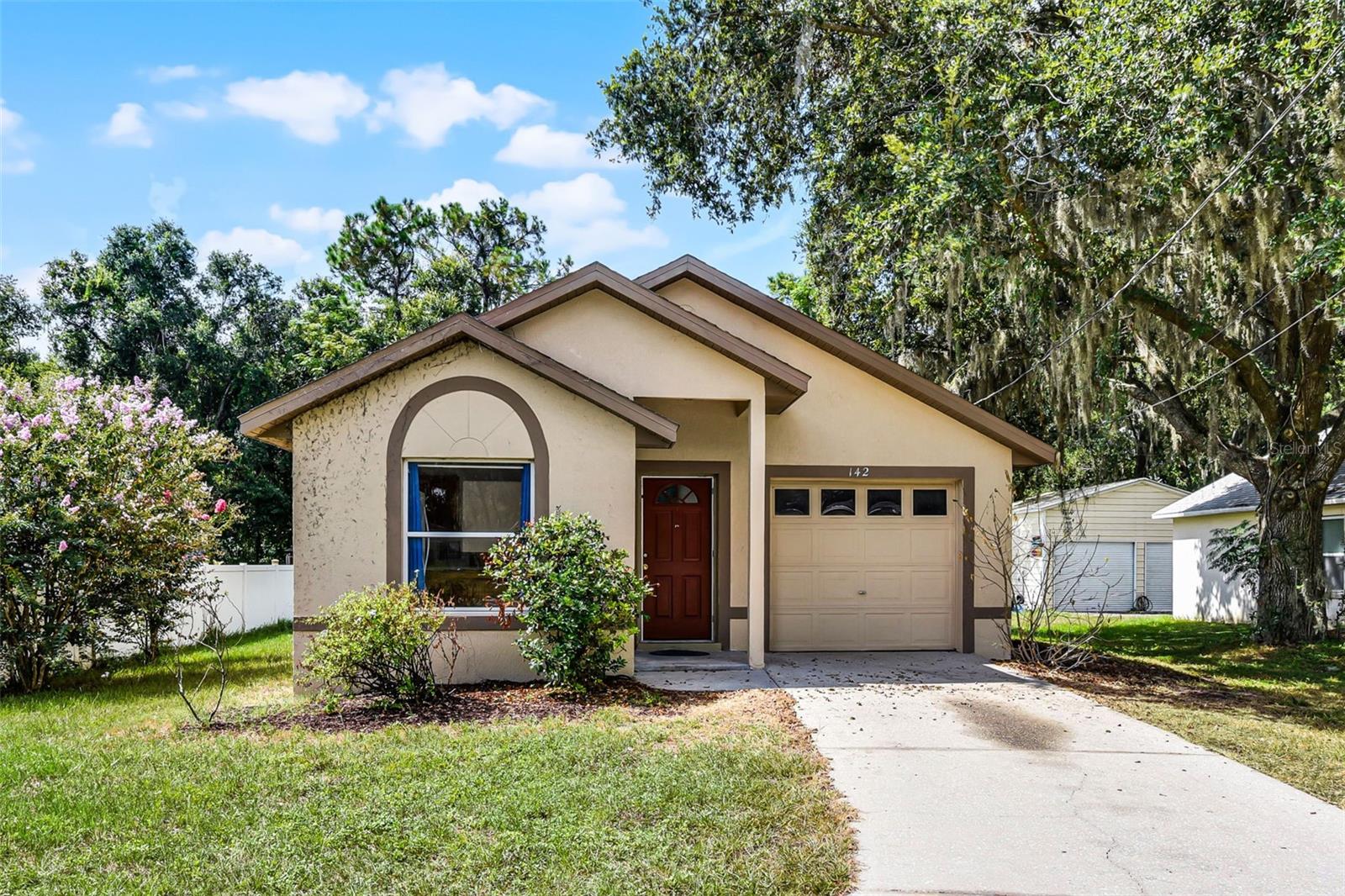 Welcome to 142 E Phelps Street — an adorable 3-bedroom, 2-bathroom home with a 1-car garage, perfectly situated on just over a ¼-acre lot with no HOA. This home features ceramic tile flooring throughout, an eat-in kitchen with a convenient pass-through to the living area, and a brand-new AC unit installed in March 2025. All of the bedrooms provide plenty of natural light and have ample closet space. Located near downtown Groveland, you’ll enjoy easy access to local shops, dining, and community events. Plus, it’s ideally located close to major highways, shopping centers, and the scenic Clermont Chain of Lakes. Perfect for both convenience and recreation.