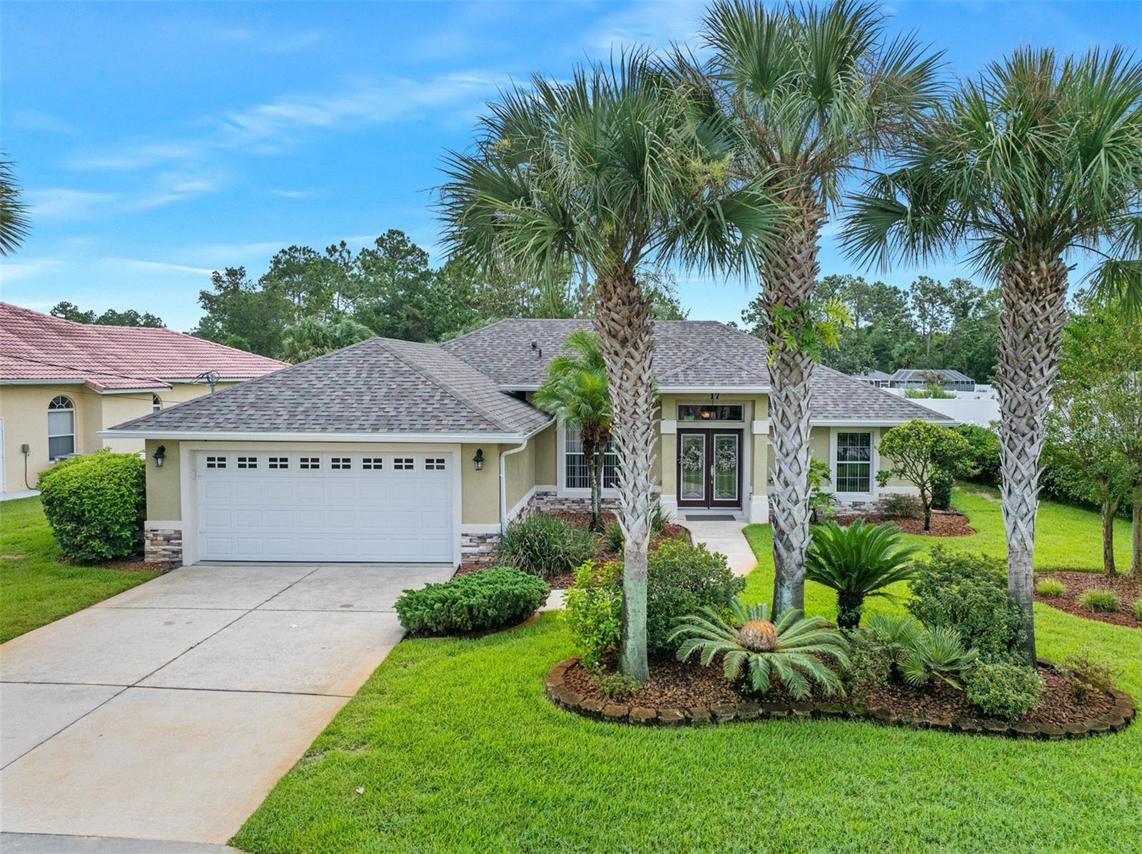 Beautifully maintained 3-bedroom, 2-bath home located in the heart of Palm Coast. Conveniently close to schools and shopping, this updated residence features a dream kitchen with stone counter tops and raised wood cabinetry and an inside laundry room for added convenience.. The spacious great room includes an additional dining area and foyer with updated glass front doors letting in abundance of light. Step outside to a recently screened lanai overlooking a stunning backyard, complete with privacy hedges and lush landscaping. Enjoy peace of mind with a brand new roof installed in 2025. Discover your perfect Florida oasis today!