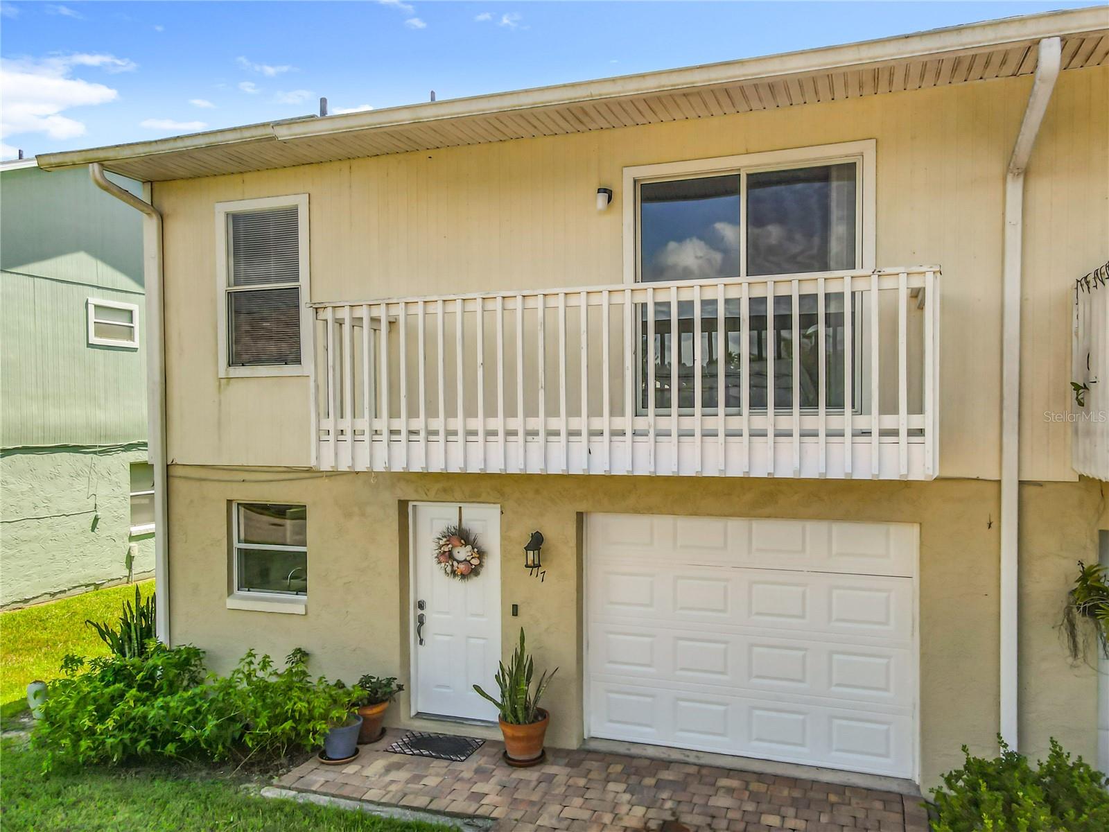 This is your chance to own a townhome just 1/2 mile from New Smyrna Beach. Enjoy golf cart living at its finest. This townhouse has no rental restrictions. You can purchase your personal vacation property , full time living or an income generating property. Offered below market value. Low traffic street Seven miles to Canaveral National Seashore. This includes miles of undeveloped beaches and some of the best beaches on the east coast of Florida.
Enter into the kitchen and you're greeted by an open floor plan where you can use your imagination to renovate or move right in. Gorgeous green luscious private views from your living room and kitchen. Enjoy dinner out on the private back patio during our chilly winter nights. Laundry room is located downstairs with plenty of space for storage or add an extra pantry allowing for full size washer and dryer. Two doors that allow you access to your private attached garage. One door right by the front door and one door in the laundry room which is excellent for creating a mud room if necessary. There is also a half bath downstairs with brand new flooring for ease on you and your guests. Head upstairs and feel the brand new carpet on your toes. There are 3 bedrooms upstairs high vaulted ceilings with walk-in closets. Two private balconies with one off the primary and one off the second bedroom. A second full bathroom and additional closet for storage are located in the hallway. The primary bedroom has a large walk-in closet with a bathroom suit attached along with a private balcony. Roof 2018, AC 2020, exterior paint 2022, new carpet and no rental restrictions. $140/ month HOA
.5 miles from New Smyrna Beach, kayak and park launch just down the street, Publix , restaurants, schools and shopping are a quick golf cart ride away. Enjoy the beauty of New Smyrna Beach from your very own backyward.