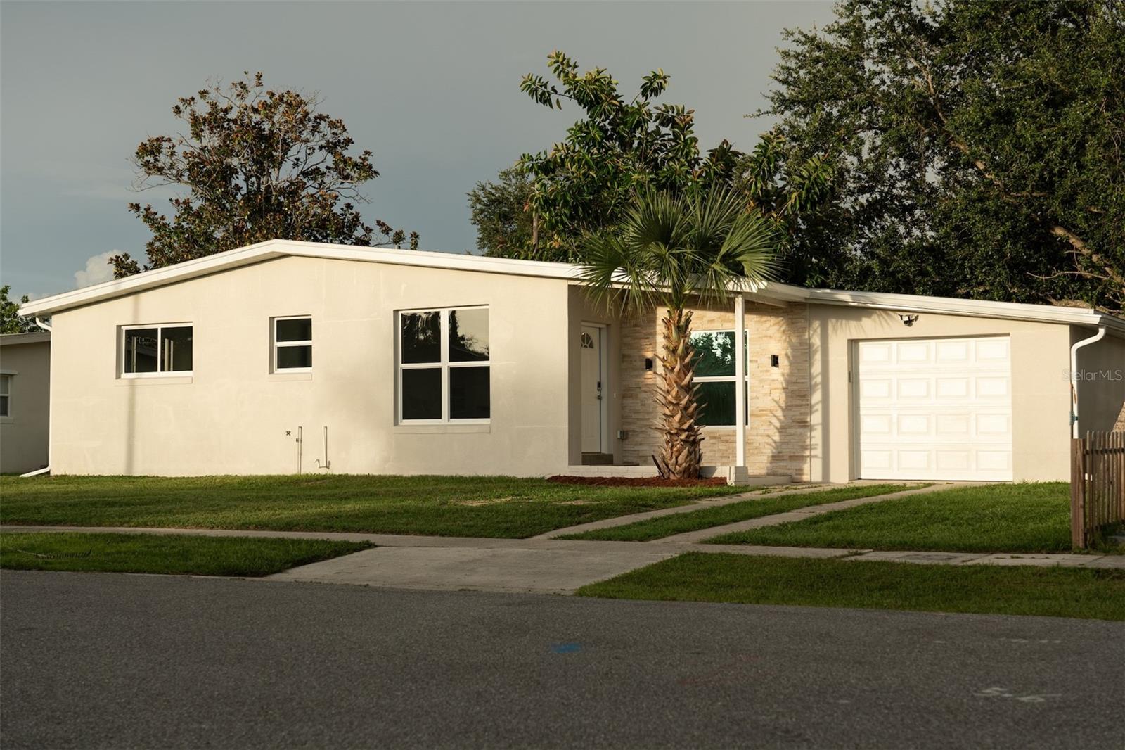 Welcome to this fully renovated 3-bedroom, 2-bathroom home in Port Charlotte, completely rebuilt from the ground up—feels like new construction! Every detail has been thoughtfully updated: brand-new impact windows and doors for peace of mind and potential savings on homeowners insurance, new A/C system, water heater, plumbing, electrical panel, and modern porcelain tile flooring throughout. The open-concept layout features a bright living area flowing into a stylish kitchen with quartz countertops, solid wood cabinetry, and pre-wired under-cabinet lighting, plus installed upper cabinet lights that create a modern and cozy ambiance. Enjoy ceiling fans in every room, abundant natural light, and a spacious backyard with room for a pool. The home boasts outstanding curb appeal with a unique and modern front elevation, new garage door, and rain gutters. Public water and sewer. No HOA! Under a minute from Tamiami Trail, shopping, dining, and Port Charlotte Beach Park. Ideal for first-time buyers or as a short- or long-term rental investment.