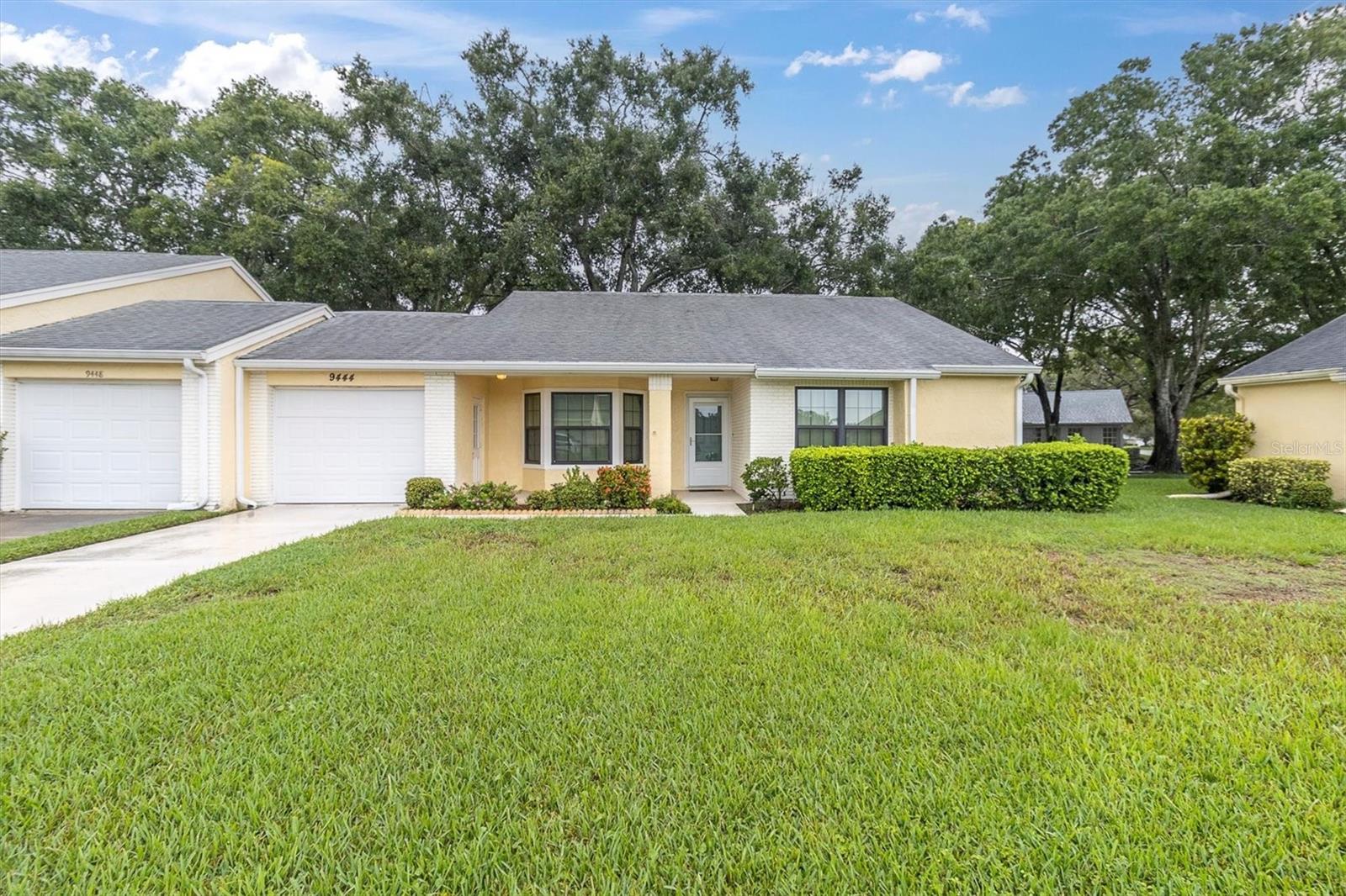 IN IMPECCABLE CONDITION WITH UPGRADES, THIS OPEN BRIGHT 2/2/1 END UNIT CONDO IS IDEALLY LOCATED IN ONE OF TRINITY'S MOST POPULAR AND AFFORDABLE OVER 55 COMMUNITY'S! LOVE THE NEW WINDOWS WITH HURRICANE CLOSURES! THE SPACIOUS GREAT ROOM FEATURES A DRY BAR, PERFECT FOR ENTERTAINING! THE BRIGHT EAT IN KITCHEN IS LINED IN CABINETS, IS COMPLETE WITH ALL APPLINACES, THERE IS A HANDY PANTRY. IT ALSO OPENS TO THE FORMAL DINING ROOM. ENJOY THE CONVENIENCE OF A LAUNDRY CLOSET LOCATED IN THE FAMILY ROOM. BOTH BEDROOMS ARE A GENEROUS SIZE, BOTH HAVE WALK IN CLOSETS! THE PRIMARY HAS A PRIVATE BATH WITH DUAL SINKS. THE ATTACHED GARAGE HAS A NEWER OVERHEARD HURRICANE DOOR. YOU CAN TAKE A STROLL DOWN WINDING TREE LINED STREETS DOTTED WITH SERENE PONDS TO THE ACTIVE CLUBHOUSE. IT OFFERS MORE ACTIVITIES THAN YOU CAN KEEP UP WITH! HEATED POOL & SPA, TENNIS CTS, PICKLEBALL, BOCCE, SHUFFELBRD, POOL & BILLIARD ROOM, EXERCISE CLASS, LIBRARY, CRAFTS, CARD CLUB, DANCES, PARTIES, BBQ'S THE LIST IS ENDLESS! ADD IN ALL THE AMENITIES A TRINITY AREA LOCATION GIVES AND YOU HAVE A RARE FIND! YOU BETTER RUN TO THIS ONE IT IS PRICED RAZOR SHARP! HESITATE... AND YOU'LL BE TOO LATE!