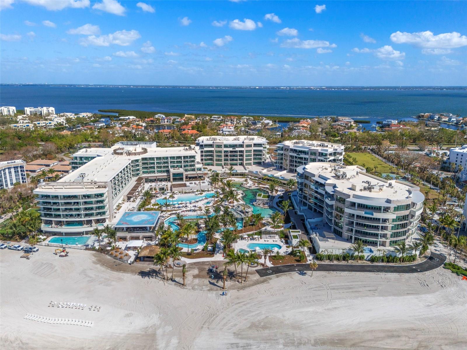 The Residences at The St. Regis Longboat Key is the first branded residential community and ultra-luxe 5-star resort hotel on the Gulf of Mexico. Welcome home to the legendary services of The St. Regis with the allure of a seaside getaway on the secluded barrier island of Longboat Key, FL. Beautifully appointed interiors with soaring ceilings and floor to ceiling sliding doors wrapping around the gathering room, dining room and kitchen provide views of sunrise or sunset skies. The gourmet kitchen includes Wolf and Sub-Zero appliances, including 6-burner gas cooktop, double ovens and panel ready side-by-side refrigerator/freezer. Owner’s suite is appointed with a spacious walk-in closet, frameless walk-in shower, and private W/C. Semi-Private elevator with keyless entry takes you directly from your private garage into the residence.
The Residences are nestled within the 17 acres beachfront resort on Sarasota’s most coveted barrier island. Amenities are unparalleled and include access the St. Regis Resort plus the signature St. Regis Butler and Concierge services, Resident-only pool and spa, and a Private Resident’s Clubhouse, fitness center and beachside cabanas.
Just steps away, residents can also immerse themselves in the St. Regis Longboat Key Resort including the private beach, pools with personal cabanas, family-friendly winding waterway and the exclusive saltwater lagoon wildlife experience complete with resident Aldabra tortoises. Escape to the sanctuary of our world-class oceanfront spa featuring vitality pools or one of the vibrant chef-driven dining outlets.