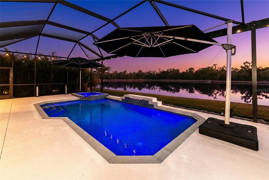 A remarkable southern-facing water view makes an immediate impression the moment you arrive. The sparkling heated pool and spa serve as the focal point of the outdoor living space, overlooking the lake and preserve beyond. This is a premium homesite for the highly sought-after Aruba model. The backyard is fully fenced, offering both privacy and peace of mind for pets.

Built by Medallion Homes, this thoughtfully upgraded smart home blends comfort, technology, and design. Advanced lighting controls, updated luxury vinyl plank flooring, and carefully selected finishes create a cohesive and elevated feel throughout. The open great room layout is anchored by dual fireplaces and flows seamlessly into a chef-inspired kitchen featuring premium quartz countertops with a waterfall edge, an impressive designer backsplash, updated appliances, and a natural gas cooktop.

The outdoor summer kitchen expands the living space and is well equipped for entertaining, offering multiple cooking options from a flat cooktop to a traditional grill.

Two spacious guest bedrooms share a well-appointed bath with a pocket door for added privacy. The primary suite enjoys tranquil water views through sliding glass doors and features dual vanities, a walk-in shower, and a generous walk-in closet. A large den offers flexibility for a home office, media room, or optional fourth bedroom.

Throughout the home you will notice numerous architectural accents and designer touches. It presents in meticulous condition and reflects genuine pride of ownership. The current owner invested in meaningful and well-planned upgrades that elevate the home beyond its original build quality.

The three-car garage is finished with epoxy flooring, added insulation, and a mini split system for year-round climate control.

Located in the gated Twin Rivers Reserve community with low HOA fees and no CDD. Review the 3D virtual tour for a closer look at this exceptional property.