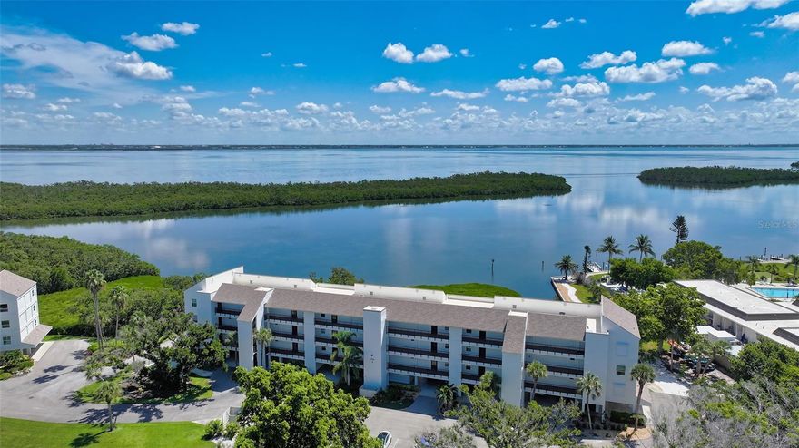 Experience breathtaking Sarasota Bay views from every room in this beautifully customized Windward Bay condominium. This coastal retreat offers a seamless blend of elegance and comfort, featuring designer upgrades and thoughtful touches throughout. The open-concept living area is centered around a stunning custom fireplace — a feature that adds warmth and character to the space.
Walls of windows fill the home with natural light and frame serene, panoramic bay and marina views, where dolphins, manatees, and pelicans glide across the water. The modern kitchen is equipped with stainless steel appliances and stylish finishes, while the spacious primary suite includes a generous walk-in closet and dressing area.
Step onto the enclosed lanai, tiled underfoot, and savor peaceful mornings watching the sunrise over the bay. Every detail has been carefully curated — from updated flooring and custom woodwork to contemporart fixtures and generous storage throughout.
Residents of pet friendly Windward Bay enjoy resort-style amenities including two heated pools, tennis and pickleball courts, fitness center, marinas with boat slips(fee and wait list), kayak storage, and deeded beach access just across the street. Perfectly located near Bayfront Park, shopping, dining, and St. Armands Circle, this home offers the best of Longboat Key living — tranquil, refined, and unmistakably coastal. Welcome home to the kind of life you don't just dream of-you live it here!