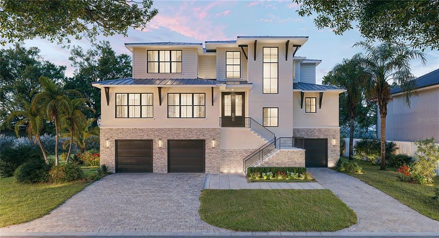 Under Construction. The exterior presentation of this spectacular waterfront residence is most impressive with its blend of modern architecture and refined luxury. With superior elevation high above the water’s edge on Siesta Key’s prestigious Bay Island, this new to-be-built 4,310 sq. ft. residence is an unparalleled oasis of tranquility in a breathtaking setting. A place where architectural elegance and natural beauty converge in perfect harmony with elaborate artisanal work, functional design, and top-tier amenities. For boaters, the location is ideal with a new seawall and a private dock allowing quick access to the bay and gulf beyond. Built with intention and quality, large windows flood the space with natural light illuminating the graceful enhancements within. When entering the home through the 4-car garage, an elevator takes you to the first and second living levels. An elegant foyer entry with double-height ceiling and sleek iron-railed staircase usher you into the spacious interiors where every detail, from the fluid layout to the custom finishes, is thoughtfully curated. Adding a distinctive touch to the stunning great room are 20-foot ceilings and a two-story entertainment wall flanked by artistic display niches. A wall of glass sliders sets a dramatic tone, framing water views and uniting indoor-outdoor living. Designed for effortless entertaining and timeless family gatherings, the outdoor area overlooks the water to create a tranquil setting that feels both secluded and well-connected. With nearly 500 sq. ft. of covered lanai, an outdoor cook center and a heated pool/spa, there’s ample opportunity for hosting special gatherings or simply enjoying the quiet beauty laid before you. Lovely landscaping, lush greenery and outdoor spaces add to the home's overall aesthetic appeal. A remarkable gourmet kitchen is designed for functionality and style, equipped with high-end finishes, top-tier appliances, a large island and a butler’s pantry with additional refrigerator and dishwasher. An adjoining dining room comfortably seats 8-10 and offers wonderful water views while dining. The primary wing is remarkable with an exquisite spa bath, enlarged customized wardrobe room, and direct access to the laundry facilities. The first level also includes a den suite ideal for remote work or creative pursuits and a completely private guest bedroom with its own full bath. Upstairs, there’s an overlook to the great room below, 2 bedrooms, 2 full baths, and an amazingly-sized bonus room with private balcony. The award-winning and talented team of professionals at Allegra Homes has thoughtfully and expertly created a residence offering a secure, exclusive lifestyle in one of Sarasota's most sought-after and high-value areas. The construction quality is of the highest standard, ensuring that the home is both beautiful and built to last. Just minutes to the mainland, downtown’s cultural mecca, world-class dining and shopping venues, gorgeous area beaches and a top-ranked school system coveted by families for generations, the prized waterfront location couldn’t be better. Showcasing extraordinary craftsmanship throughout, this never-lived-in showplace is the ultimate vision for those who value the very best of coastal Florida living. There’s still time to make your own personal choices for creating the perfect custom home tailored to your family’s taste and style.