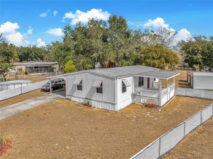 Welcome home to this cozy 3-bedroom, 2 bath, 1032 sq. ft., double wide manufactured home nestled at the end of a quiet cul-de-sac in Mount Olive Heights Community of Polk City. Situated on a .3-acre lot with no HOA this property offers privacy and flexibility. Built in 1984 this home offers a comfortable split floorplan with newer counter tops in the kitchen and an inside laundry room for convenience. Enjoy outdoor living with a 20'-10' covered front porch and a spacious 29'x12 screened in back patio perfect for relaxing or entertaining. Additional highlights include a carport, 3 storage sheds, expansive fenced in yard perfect for your pets. Conveniently located close to I-4 and the Parkway.