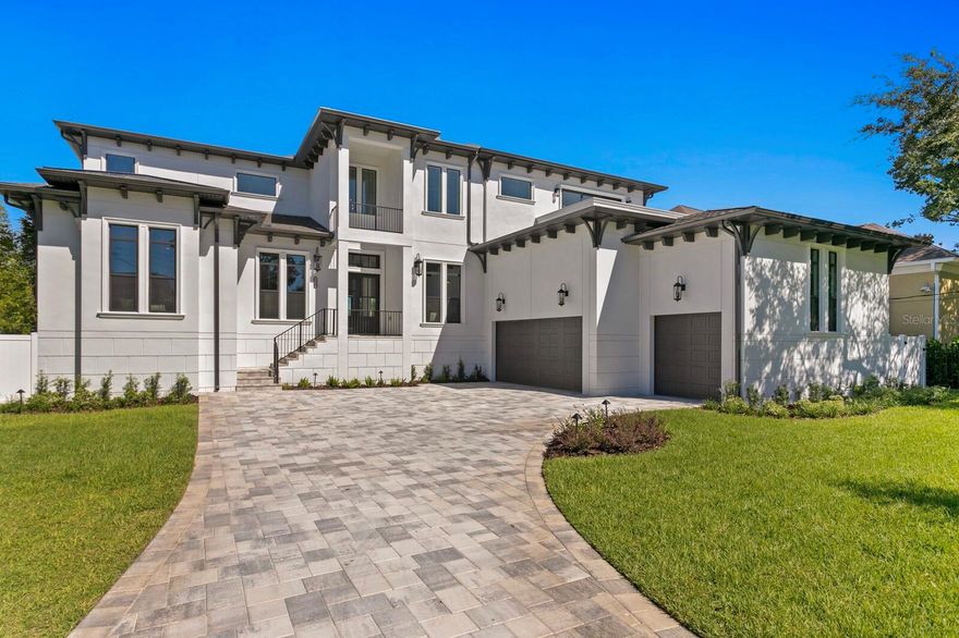 Built to the newest codes and standing strong! Coastal Contemporary New Construction on iconic Bayshore Boulevard in sought after Ballast Point.  Presented by BNCH Inc, Tampa custom home builder, a grand drive and stunning custom Mahogony double door entry deliver a welcoming entrance to this flowing floor plan offering abundant natural light, dramatic two-story ceilings and luxurious appointments throughout. Featuring a refined attention to detail and quality throughout, a formal dining room with 24+ foot ceiling, living room with a 48” fireplace and custom stone mantle, office and luxurious first floor primary suite, statement lighting, European White Oak wide plank hardwood floors and state-of-the-art construction to current building codes and elevation. Full retracting glass doors lead to the covered terrace, overlooking the pool, that provides the perfect location for dining and entertaining. Exposed beams provide connection between the living room and bright white Geneva quartz kitchen with center island and top-of-the-line Viking stainless appliances, custom hood, breakfast area, pantry and terrace access. A private hallway leads to the luxurious primary retreat with his/her closets, opulent bath, separate water closet, soaking tub, premium appointments and expansive glass-enclosed shower. An additional ensuite bedroom/in law suite with separate exterior entrance, guest bathroom, drop zone storage and laundry room are also included on the first level. Upstairs, enjoy three generous ensuite guest bedrooms along with a bonus room that offers an entertaining wet bar and beverage refrigerators, with a private terrace and peak-a-boo water view. A private backyard oasis features an outdoor kitchen, pool and spa with wireless control, spacious pool deck and fully fenced backyard with tropical landscape. Additional appointments in this Smart Ready home include Impact Doors/Window, Rinnai  tankless water heaters, 3 Trane HVAC units, 3-car garage with additional storage capacity and epoxy floor finish. Located near great shopping and restaurants, outdoor recreation, Hyde Park Village, Ballast Point park and exhilarating nightlife. Embrace all that South Tampa has including walking and biking Bayshore Boulevard, Tampa Yacht Club, an intrinsic art scene and entertainment, sports venues, an array of outdoor recreation, along with the ease of access to beaches, downtown Tampa and Tampa International Airport. See virtual tour link for video, specifications and floor plan.