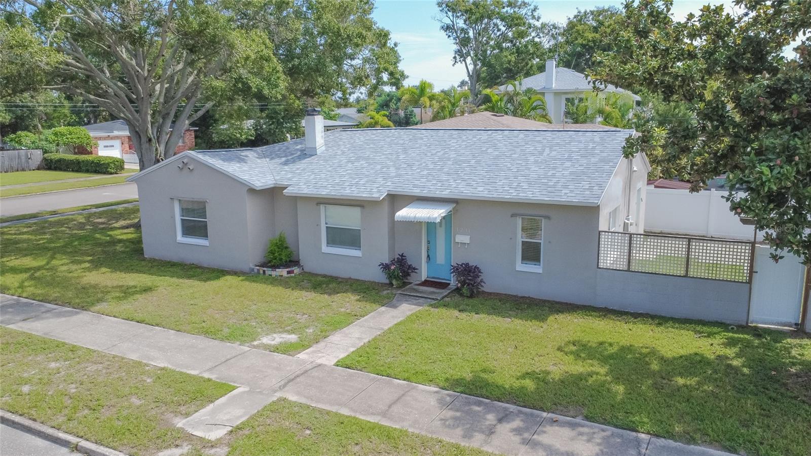 Have you been looking for a renovated home in an X Flood Zone at higher elevation? This Central Oak Park bungalow has the perfect blend of 1940s charm with all the modern amenities you could need. Welcome to 1231 48th St N in St Petersburg Florida! Situated on a large corner lot, this three bed, two bath home has endless possibilities for you to make it your own! Step inside this 1940s charmer to discover lots of updates, like recessed lighting and renovated kitchen and baths, as well as the period touches that we all love, like curved archways and a separate formal dining room. The front of the home is spacious with lots of windows that bring in tons of natural light. The dining room easily flows to the kitchen for easy entertaining to host your next dinner party. Inside the kitchen you’ll find it’s been fully updated with granite countertops, modern cabinetry, stainless steel appliances and tiled backsplash. Off the kitchen, you’ll enjoy access to the fully fenced in backyard with plenty of green space and paved porch area. With the large corner lot, detached two-car garage, and alley, you’ve got lots of options to turn this into your dream home! Inside, the main bathroom has been fully renovated with a large, dual sink vanity and relaxing Jacuzzi tub. The primary bedroom is spacious and can easily fit a king-sized bed with all your furniture needs. The front guest bedroom is generously sized and has easy access to the hall bath which is also updated with modern tile surround tub and dual sink vanity. And the third bedroom is a flexible space that can be used as a bedroom or even a nursery, office or art studio. You’ll love the convenience of having indoor laundry, and with the rare two car garage that’s detached you could even convert the garage into another living space with its own plumbing and electrical connections already in place. This home also features a brand new roof, and other main systems updates like HVAC, windows, electrical and water heater all replaced within recent years. Located at higher elevation, in the center of town, you’ll enjoy peace of mind and be conveniently located near tons of shopping and dining options, Downtown St Pete and even the beach! There are endless possibilities to make this your dream Florida bungalow in one of the most sought-after neighborhoods in St Pete. Come see this Central Oak Park gem and start living your Florida lifestyle today!
