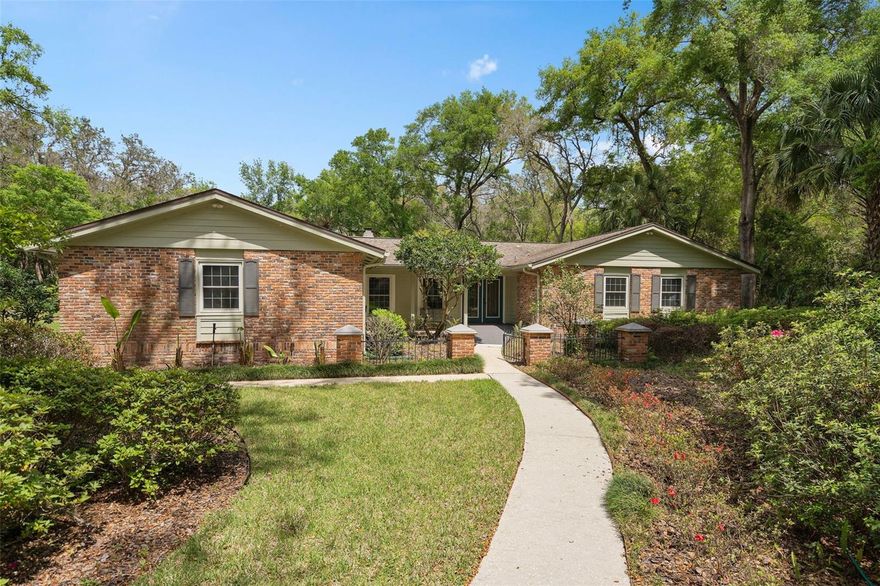 Nestled within the highly sought-after Markham Woods corridor, this exceptional estate is gracefully positioned on a quiet, tree-lined street in the serene enclave of Trilby Bend. Set on an expansive 2.6-acre homesite, the property offers a private, park-like setting surrounded by mature trees and the natural beauty of Florida’s landscape where deer, fox, owls, and native wildlife are often part of the view.

This one-owner residence reflects impeccable care and pride of ownership, with timeless curb appeal enhanced by lush landscaping, a circular drive, classic shutters, and a stately brick façade accented by four grand columns. From the moment you arrive, the home exudes warmth, charm, and enduring Southern elegance.

Enter through the striking stained-glass double doors into a welcoming formal living and dining space, where rich wood flooring and a cozy brick fireplace create an inviting atmosphere for both everyday living and refined entertaining.

At the heart of the home lies a beautifully appointed chef’s kitchen, thoughtfully designed to balance style and function. Outfitted with high-end appliances, a serving bar, and a center island, the space is highlighted by exotic Persian Treasure granite countertops, custom Cinnamon cabinetry, pendant lighting, a tiled backsplash, and a fully equipped butler’s pantry ideal for hosting with ease.

The spacious owner’s retreat offers a tranquil escape, filled with natural light from shuttered windows and designed for comfort and relaxation. The beautifully remodeled bath showcases a furniture-style vanity with granite countertops, an expansive walk-in shower with artistic tilework, and generously designed walk-in closets.

Throughout the home, thoughtful design elements enhance livability and flow, offering a layout that is both functional and accommodating for a variety of lifestyles.

Step outside to experience true Florida living. French doors lead to an inviting lanai, while the Florida room featuring walls of glass and a warm wood-lined ceiling provides the perfect vantage point to take in sunset views over the pool and grounds. The sparkling pool is complemented by a charming gazebo and a relaxed, island-inspired cabana ideal for entertaining or unwinding in your own private retreat.

The beautifully maintained grounds extend the living experience outdoors, complete with a utility shed equipped with electricity for added convenience.

Ideally located, the Markham Woods corridor is renowned for its proximity to the Wekiva River, scenic bike trails, pristine golf courses, top-rated schools, and the Seminole Sports Complexoffering a rare blend of natural beauty and everyday convenience.

Significant updates provide peace of mind, including a roof (2018), AC (2019), siding (2019), pool enclosure (2015), whole-home generator (2024), and new windows (2024).

This is a rare opportunity to own a private estate where timeless design, modern updates, and natural surroundings come together in perfect harmony. Begin your next chapter here.