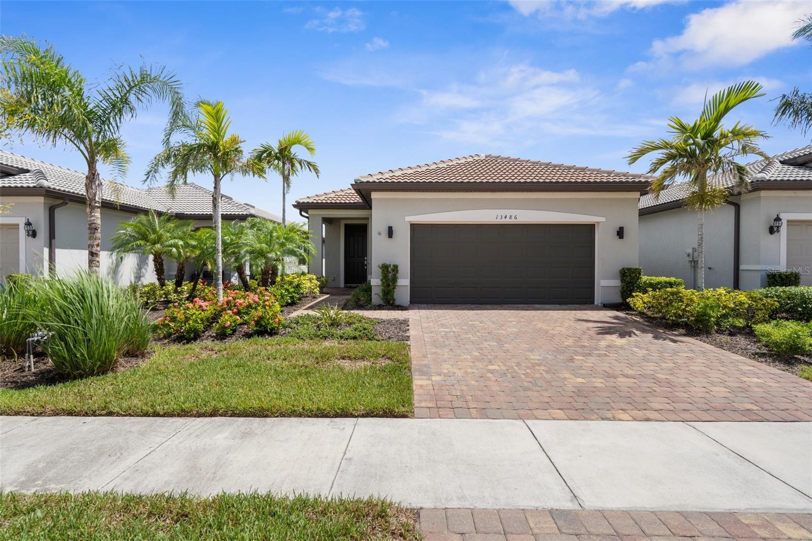 Step into comfort and style in this beautifully designed 3-bedroom, 2-bath 1,575 square feet home with bright, open-concept living perfect for relaxing or entertaining. Move outdoors to your spacious covered lanai, positioned along one of IslandWalk’s scenic waterways—an ideal spot to savor breathtaking sunrises, dazzling sunsets, thrilling rocket launches, and festive fireworks, all from the comfort of home. This may be the only one in Islandwalk featuring the sleek clean lines of flat panel cabinetry, set apart with a modern flair. The Maple Latte soft neutral tones paired with quartz countertops really give a chic look to the kitchen. What everyone loves about this home design is the kitchen! So much room for entertaining with that huge island as a focal point. Additional features include modern ceiling fans that draw the eye upward, accentuating the home's tall ceilings. With blinds on all windows, no need for the expense of purchasing window treatments. For ease of use, you will find hurricane accordion shutters on all windows and sliding door. Not found often - a water softener system, gentle on clothes and appliances. Flex room with closet and french doors - ideal as a bedroom, office or den. You will have the luxury of extra space with a deeper garage than found in most homes this size. Neutral tile flooring throughout with carpet in the primary and one guest bedroom(Seller offering credit for carpet condition in primary bedroom). Both bathrooms have coastal white cabinetry with the quartz countertop - same as kitchen. Islandwalk is renowned as one of VENICE'S largest and MOST DESIRED communities. With a full-time activity director, numerous events, clubs and activities, residents enjoy an active and social lifestyle. The community boasts 2 clubhouses, an event center, 2 resort-style pools, a lap pool, 12 pickleball courts, Har Tru tennis courts, dog park, playground, basketball court, miles of nature/biking trails. Venetian bridges and scenic water views complete this picturesque resort lifestyle. One of the great advantages of Islandwalk is that it doesn't require flood insurance and the entire community is maintenance-assisted. The Atlanta Braves Spring Training Stadium is just a short bike ride away, providing year-round events and activities for more than just sports enthusiasts. Another convenience is the completion of the new Downtown Wellen: Publix supermarket, restaurants, coffee places, shopping options, gas station and more! All of these amenities are just a short street-legal golf cart ride away. What are you waiting for? ENJOY the FLORIDA sunshine! Isn't it time to live the carefree lifestyle you’ve always dreamed of?