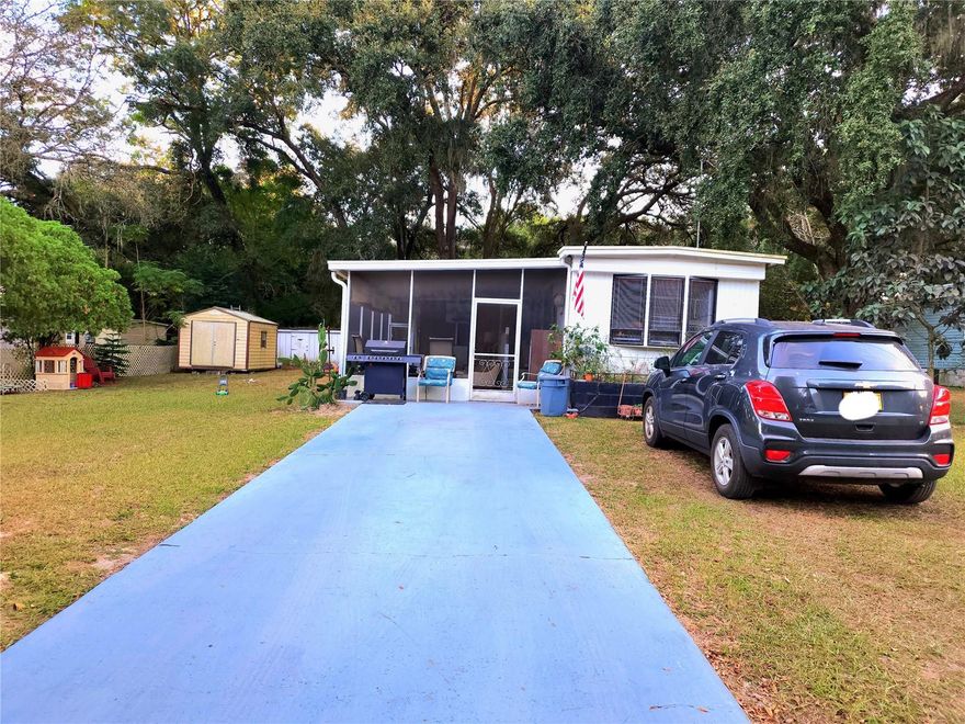 Check out this well lit home with land (0.27 acres) located close to shopping, with no home owner's association. This 3 bedroom, 1 bath home features a large living room with sliding glass doors leading to the large screened porch, perfect for enjoying morning sunrise and shade in the evenings. The kitchen features eating space and new backsplash.  Main bedroom leads out to bonus room with laundry and storage space at the end of the house.  The kitchen floors and bathroom floors were replaced in 2022. Central A/C installed in 2021. 3rd bedroom was built in 2022 and has it's own room A/C unit. Entire interior was repainted in 2023. Exterior features two storage sheds, a large shade tree and a fence on the East side of the property. Enjoy your days in the shaded back yard. Home has a propane tank for the gas stove. Schedule your showing today. Priced to sell.  Bring all offers.