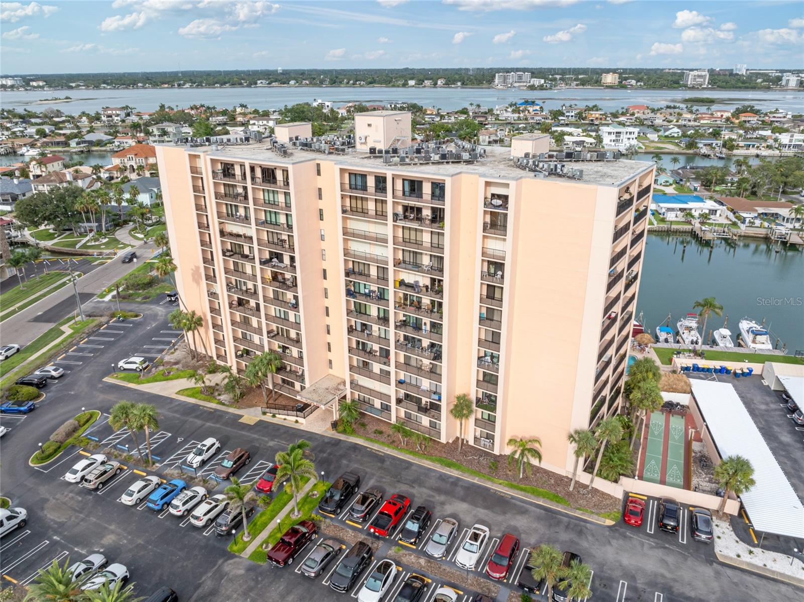 Live every day like a VACAY at 51 Island Way, Unit 411! This stunningly updated end-unit offers 2 bedrooms, 2 bathrooms, and TWO private balconies, all located in one of the most sought-after waterfront buildings on Island Estates. Situated on the coveted northeast corner, this residence delivers sweeping views of the Intracoastal, Gulf of Mexico, Clearwater Beach, and downtown skylines—right from your living room.
Step inside and you’ll immediately notice the abundance of natural light pouring through the hurricane-rated sliding glass doors. The layout has been thoughtfully redesigned with a modern touch—walls removed to create an open-concept floor plan, perfect for entertaining and everyday comfort. The kitchen, bathrooms, flooring, paint, and trim have all been updated to reflect a clean and timeless aesthetic.
The king-sized primary suite offers incredible water views, balcony access, a spacious walk-in closet, and a beautifully remodeled ensuite bathroom complete with a walk-in rain shower. The second bedroom also features balcony access and overlooks the water, Island Estates, and the iconic Clearwater Marine Aquarium.
This residence comes with access to an extensive list of resort-style amenities including:
• Oversized heated waterfront pool and spa
• Tiki bar with large-screen TV—perfect for game day
• Shuffleboard, tennis, and pickleball courts
• Kayak launch, floating dock, and marina with boat slips ($60/month, first-come basis)
• Renovated his-and-her saunas and locker rooms
• Outdoor BBQ grills, waterfront seating areas, and a community library/rec room
• Secured keyless lobby entry, open and optional covered parking
• Storage locker on the same floor and commercial laundry rooms on every level
Your HOA dues cover cable, high-speed internet, water, sewer, trash, building insurance, reserves, and on-site management—giving you truly low-maintenance living.
All of this is just a short ways or Jolley Trolley ride to Clearwater Beach, Pier 60, top-rated restaurants, and nightlife. You're also steps from Island Estates’ own Publix, shops, dining, gas station, bank, and more.
Whether you’re seeking a full-time residence or a beachside escape, this one-of-a-kind corner unit offers the perfect blend of luxury, location, and lifestyle. Don’t miss this opportunity—schedule your private showing today!