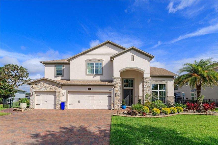 LAKEFRONT ON SKIABLE LAKE WITH PRIVATE BOAT DOCK, BOAT LIFT AND JET SKI LIFT. BEAUTIFUL SUNSETS EVERY NIGHT along Johns Lake. This 5,183 sq. ft. home features 5 bedrooms, 6 full baths, 2 half baths plus an office, bonus room and CUSTOM soundproof theater with a 110 inch screen and reclining chairs. Home's shoreline is 135 feet. Johns Lake is over 2,400 acres and spans two counties. Spacious modern kitchen with Sub Zero fridge, ice maker, double convection oven, upgraded cabinets and more. Kitchen opens up to family Room which features a custom electric fireplace for ambience all year., custom remote control draperies; surround sound and stackable sliding doors to adjoining pool area. Relax in your lanai with lakefront views, power screens overlooking the salt water infinity pool and spa. Large pool area with 2 fire bowls and 10 x 10 swim deck. Summer kitchen has built in green egg, 42" Alfresco Gas Grill, fridge, ice maker, bar area, outdoor TV and more for entertaining after a day on the lake. Boat dock is top of the line with weather resistant deck, covered sitting area and covered boat lift.  With acceptable offer the Ski Nautique boat and Jet Ski will be included. Master bedroom is downstairs with custom finishes and views of the lake. His & hers custom built in closets. The master bathroom has spacious walk-in double shower, soaking tub, and his & her vanities. One other bedroom is downstairs away from the main living area; perfect for guests. Upstairs is a spacious loft with built in bar & beverage center. Pool table & arcade w/30 different games are included in sale of house. Half bath in loft area as guests enjoy a game of pool. Take the party out to the private 2nd story balcony to view amazing sunsets. Three spacious ensuite bedrooms are located upstairs to complete this home. One of the upstairs bedrooms is a second owner’s suite or   in-law suite. Oversized 3 car garage w/ epoxy flooring, custom built cabinets, work area & plenty of overhead storage. No neighbor in front as this home is across from a large pond. Community offers resort level amenities including gated community, clubhouse, fitness center, pool, walking trails, volley ball area, tennis courts, playground, BBQ area, viewing dock and picnic area. Conveniently
located to downtown Winter Garden, Winter Garden Village, most highways, shops, restaurants, and night spots. Just 15 minutes to Disney and under 25 minutes to downtown Orlando. This home is in pristine condition and has designer touches throughout. Your home will be a piece of paradise in Central Florida. Live the “Lake Life” and enjoy over 2,400 acres of water by boat, paddle board, kayak, or Jet Ski.   Call to set up an appointment.