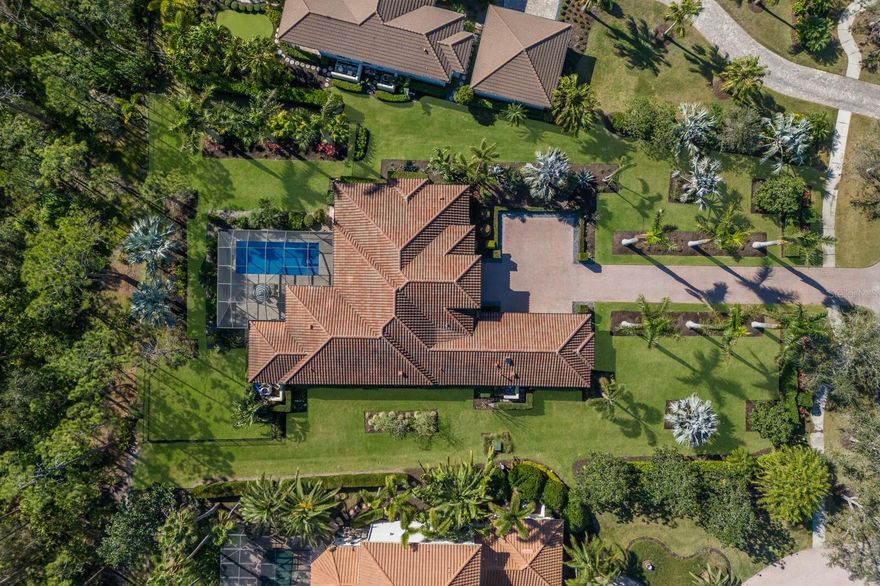 Make your way down the long paver drive lined by dramatically uplit Royal Palms and meticulously manicured grounds that stretch across more than three-quarters of an acre. 19424 Ganton Avenue stands in the distance, a masterpiece of design and luxury, framed by the towering presence of Florida pines and ancient 200-year-old oaks in the backdrop. This stunning contemporary home is filled with the finest finishes yet has comfort and family in mind. The grand room makes a statement from the moment you enter with soaring ceilings, professionally styled interiors, custom trim work, built-ins, crown mouldings, a linear fireplace, and bespoke lighting. 10-foot-high by 22-foot-wide pocket sliding doors offer an unobstructed view of the nature outside. Impact glass protects the entire home from the outside world, but within, the ambiance is filled with tranquility and refinement. The gorgeous kitchen makes a statement in this residence boasting gas Thermador appliances, fine custom cabinetry with soft-close drawers and pull-out shelves, dramatic quartz countertops, and a massive island which serves as a gathering spot for family and friends. Glass-front cabinets illuminate from within to showcase your family's most important pieces and a 10-foot-tall glass-enclosed dual-sided wine display, is a showpiece that reveals your carefully selected vintages. Throughout the house, every detail is a testament to the homeowners' desire for perfection.  The primary suite is a luxurious retreat with access to the lanai, two custom-organized walk-in closets, a spacious marble vanity, crown molding, a large pass through shower, and a free-standing tub. The office features tall arched windows, high ceilings, and glass doors. Each of the two guest bedrooms have generous closet space and en-suite bathrooms. The bonus room, just off the great room, opens directly to the expansive covered lanai, where the true luxury of this home comes to life. The travertine deck stays cool in the late afternoon sun and surrounds a salt water pool and spa. The substantial summer kitchen—equipped with a granite-topped island, Blaze professional grill, Marvel outdoor fridge, prep sink, and a massive vent hood—welcomes outdoor dining and entertaining. It is in the tranquility of the fully fenced backyard, however, where the true drama unfolds. The serenity of the surroundings, the beauty of the perfectly curated landscape, sculpted hedges, and the majesty of the unspoiled 60+ acre forest all combined to create a rare kind of peace that is not easily obtained.  Bordering Lakewood Ranch, residents of the Concession enjoy all of the activity in and around the area but enjoy no CDDs, more spacious estate lots, a high security guard gate, and optional membership to the Concession Golf and Country Club. The Concession was home to the 2021 PGA Tour World Golf Championship and the 2023 PGA World Champions Cup, and is known as one of the most prestigious golf communities in the country .