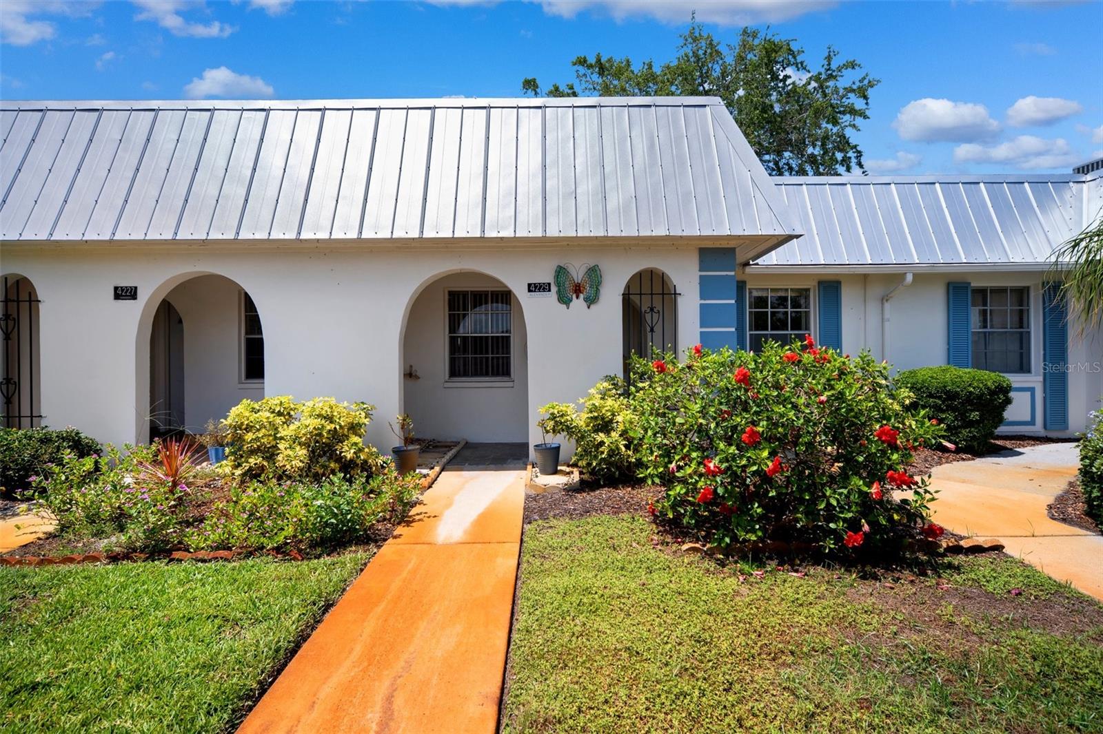 MOTIVATED SELLERS!!! Step into comfort and charm with this FULLY FURNISHED 2-bedroom, 1-bathroom condo located in a quiet, well-kept community. From the moment you arrive, you’ll be greeted by lovely landscaping, arched entryways, and a NEW sleek metal roof that adds to the home's unique curb appeal.
Inside, the open-concept living and dining area is warm and welcoming, with large tile flooring throughout and a mirrored accent wall that enhances the sense of space and light. The room flows effortlessly into a cozy sunroom that also provides outside storage which houses a NEW water heater and overlooking a lush green courtyard—perfect for reading, relaxing, or enjoying your favorite beverage.
The updated kitchen is both functional and stylish, featuring granite countertops, mosaic tile backsplash, crisp white cabinetry and a NEW refrigerator and microwave. A passthrough to the dining area makes serving and socializing easy. Both bedrooms have spacious cedar wood closets and share a bathroom that provides handicap access into the shower!
This quaint home is a true Florida charm with modern finishes, making it ideal for full-time living or a seasonal retreat. Conveniently located JUST STEPS from the club house making it conveniently accessible to all the amenities. Condo fee includes; Cable & internet, water, trash, sewer, ground maintenance, exterior maintenance, access to the pool, club house, library, laundry facility, game room and so much more!!