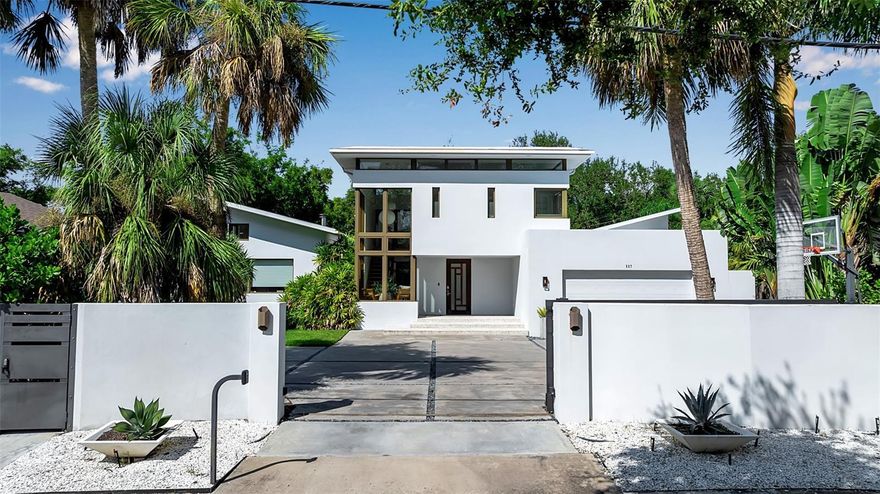 A true architectural gem, this custom-designed home, built by Bluewater Construction, has high ceilings and large windows which harmonizes beautifully with its natural surroundings. The residence wraps around a stunning 60-foot heated saltwater lap pool with a spa, all enclosed within a screened-in courtyard. This exceptional 3-bedroom, 3.5-bath home also features a private sauna, offering a spa-like retreat. A detached yet connected wing currently serves as an additional bedroom suite but could be used as a studio or gym. A new roof was added in 2025. The gated driveway provides both security and privacy as you enjoy your beautifully designed yard by DWY Landscape Architects. Nestled on a serene half-acre of wooded land in Indian Beach/Sapphire Shores, it is just a few blocks from the Ringling Museum and a quick drive to downtown Sarasota for dining, shopping, entertainment and so much more. Seller will consider offers including payment in Bitcoin, subject to title and escrow approval.