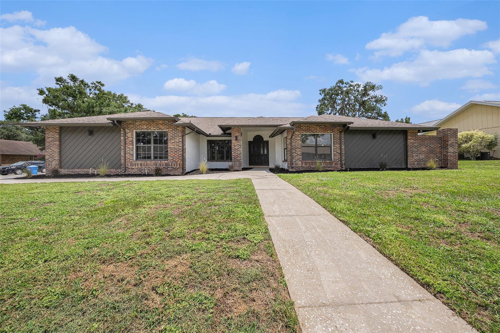 No flood zone and low optional HOA — move-in ready inside & out! Gorgeous fully renovated 4BR/ 2.5BA pool home on a quiet street in a beautiful neighborhood with sidewalks and mature trees. Situated on a stunning corner lot with a side-entry 2-car garage and privacy-fenced backyard. Spacious split floorplan with vaulted ceilings, formal living/dining area (flexible for office), open kitchen with eat-in area, and family room with fireplace. The private primary suite features pool access, dual walk-in closets, and large bath. On the opposite wing of the home are additional bedrooms, a full bath with double vanity and convenient pool access, plus a walk-in laundry room with cabinetry & sink. The interior and exterior spaces are ideal for entertaining, with a large screened-in pool and patio offering plenty of room to gather.