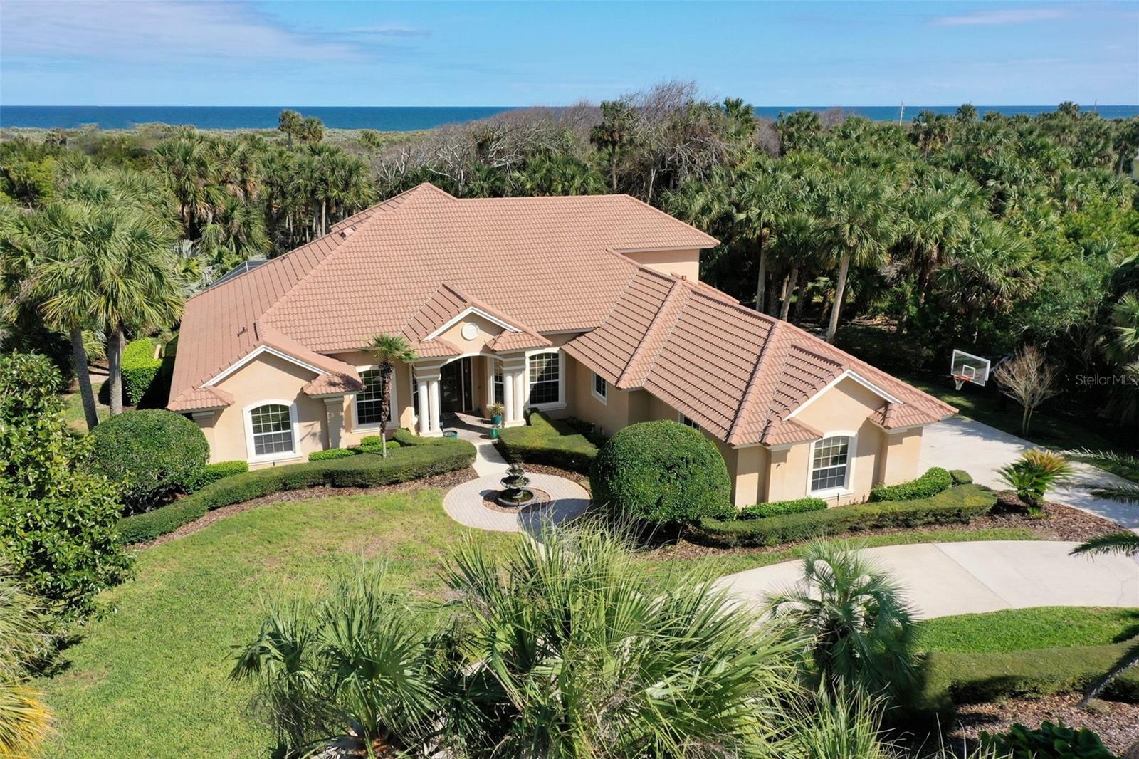 Looking to live your Florida dream life in paradise? Then look no further than this stunning, custom, Machin Design Builders home that exudes superior workmanship, an open floor plan, elegance, and charm. This amazing waterfront home is in the highly sought after, gated community of Island Estates, a 2 1/2-mile island with private, gated community access to the quiet, soft coquina beaches that Flagler County is known for. Island Estates offers a 24/7 gate staff, and is part of the golf course community of Hammock Dunes. This 4 bedroom, 3 and half bath, 4,122 sqft home with an IN-Law suite or private guest house, and bonus room that could be used as a 5th In-House bedroom, media room or what ever fits your needs, offers a seamless flow, and privacy for family and guests. The primary bedroom has private access to the pool and hot tub. Relax in the expansive primary bathroom with his & her sinks, a generous shower with two shower heads, and an oversize bathtub. The kitchen overlooks the breakfast nook, family room, and pool. Grab a blanket and snuggle up by the fireplace. Relax in the hot tub or unwind in the pool after a long day. The guest house makes for a In-Law suite with a kitchenette, and private entrance, or a guest house or 6th bedroom. If you enjoy boating and jet skiing than look no further.... This home has a covered boat house, and a floating dock that houses 3 jet skies. The Intracoastal Waterway is just minutes away! The four car garage, with custom Built-In's for tools, and storage, custom flooring, and is climate controlled! Membership to the Hammock Dunes Club is available but not required. The Oceanfront Hammock Dunes Club is ranked as an "Emerald Club of The World” Enjoy delicious meals or a quick snack in one of the 3 OCEANFRONT dining rooms or at the quaint clubhouse at the Creek Course. Hammock Dunes has two 18 Hole golf courses by Rees Jones and Tom Fazio. Hammock Dunes Club offers an OCEANFRONT Heated Pool, Kid's Splash Pad, Hot Tub, numerous community beach walkovers so you can enjoy the quiet, soft coquina beaches Flagler County is known for, A 5,000 SF Fitness Center, Tennis, Pickleball, OCEANFRONT Bocce Ball, OCEANFRONT Croquet, in addition to year-round Social Events. Flagler County is located on the Atlantic, Central Florida Coast and is just a one hour to Jacksonville or Orlando and 30 minutes to Daytona Beach or Saint Augustine. Come see why the Locals call Flagler County "Paradise" and why visitors return year after year. Schedule an appointment today and begin living the Florida dream life! ***THE SELLERS ARE OPEN TO SELLING***