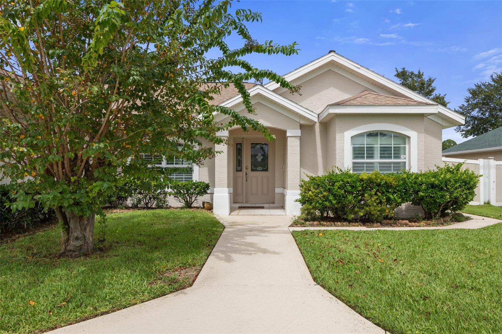 Located in the desirable F-Section of Palm Coast, this home is all about enjoying the Florida lifestyle. The backyard is fully fenced for privacy and features a gorgeous mature tree that adds both shade and character. Just off the main living area, you’ll find an extra-large screened and covered lanai — perfect for morning coffee, evening dinners, or entertaining friends year-round.
Inside, the split floor plan offers 3 bedrooms and 2 bathrooms, with the home freshly painted inside and out. It comes furnished, with the exception of the two guest bedrooms, giving you flexibility to bring your own style to those spaces. Plantation shutters throughout and easy-care tile flooring add charm and practicality.
The primary suite feels like a true retreat with a walk-in shower, and jetted tub. Two additional bedrooms provide space for family, guests, or a home office. The open layout makes everyday living comfortable and functional.
Additional highlights include a sprinkler system on well, and an attached 2-car garage with a screen door, so you can let the breezes flow while you work or relax in the garage. A circular driveway and neat landscaping complete the curb appeal.
Even better — lawncare and pest control are included in the rent, making this an easy, move-in-ready choice for your next home.