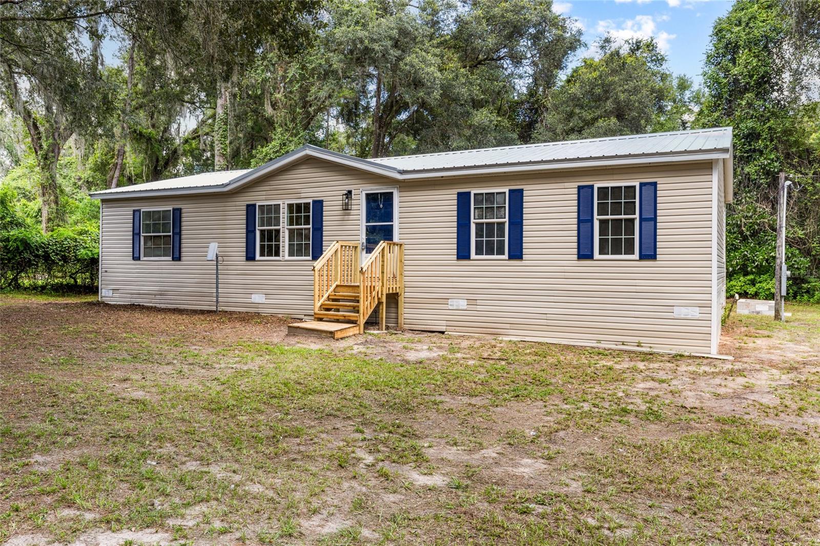 Enjoy peaceful country living in this beautifully updated 3 bedroom/2 bath with a bonus room mobile home situated on a spacious 1-acre lot. Step inside to find a bright and modern interior with fresh finishes throughout. The open floor plan offers a welcoming living area, updated kitchen, and comfortable bedrooms. The primary bathroom features an updated walk-in shower and a large tub to soak and relax in after a long day. Outside, you'll love the fire pit area- perfect for cozy nights under the stars- and the concrete slab at the front of the property, ideal for a shed, rv, or future outdoor projects. With plenty of space to spread out and no HOA this property offers the perfect blend of comfort and freedom. Conveniently located with easy access to Gainesville, Palatka, and local lakes. This home is move-in ready and waiting for you!