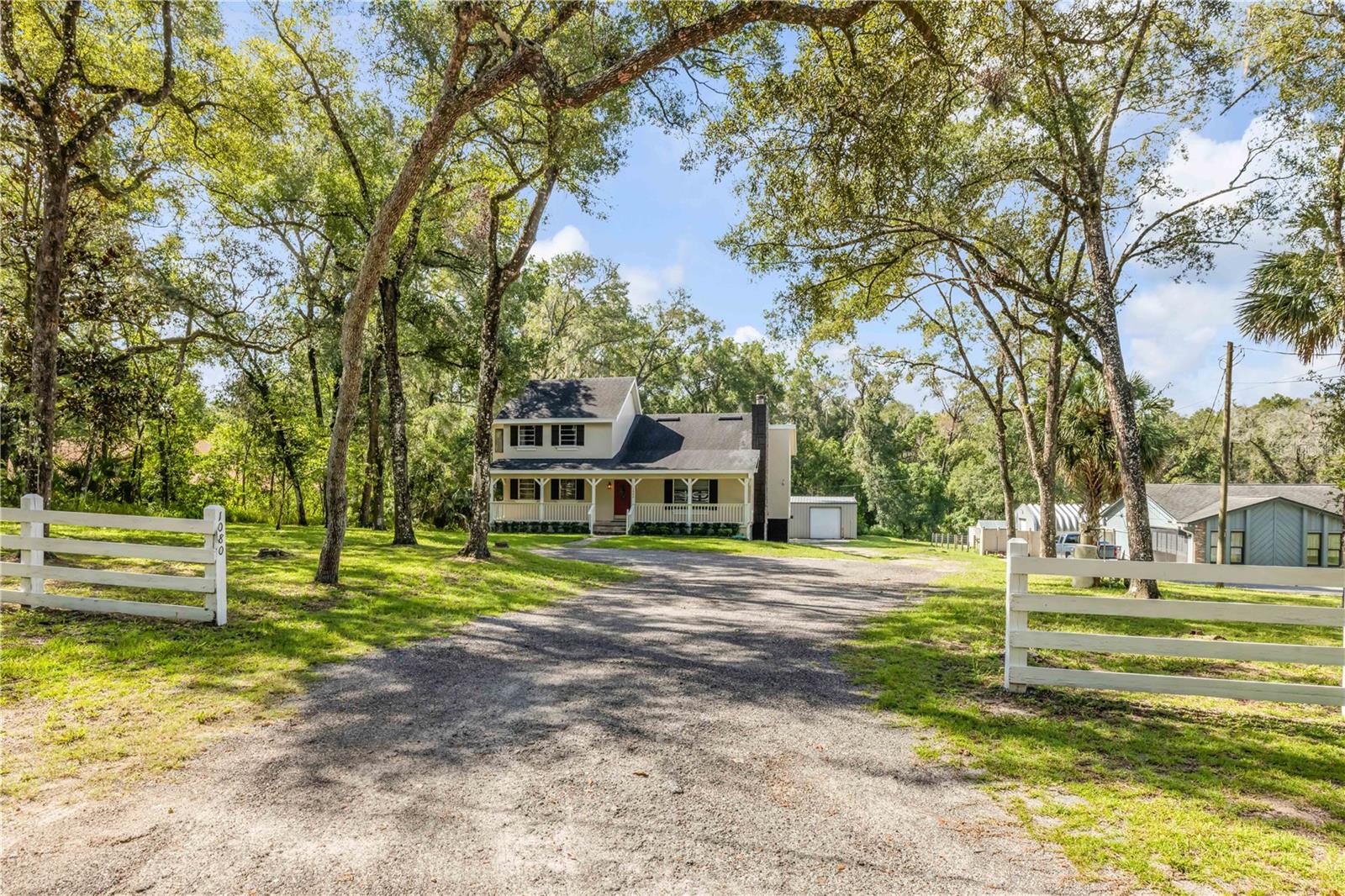 Make your dream a reality! Imagine living on a private, dead end, dirt road with space for all the toys and NO HOA!!!! Room to live, work and play in a beautiful home with an oversized workshop/garage on an expansive lot offering plenty of outdoor space and privacy. Relax on the front porch in your rocking chair sipping your morning coffee while watching the birds and wildlife. Upon entering the home, you're immediately greeted by a warm welcoming feel, with a spacious open living room and cozy fireplace. The guest bedrooms are downstairs as well as a large office/den right off the main living area. The Master Suite is located upstairs with a private balcony where you can sit in the mornings or evenings and enjoy a cocktail or cup of coffee. The kitchen is in the back of the house with plenty of space for family dinners overlooking the backyard. Step out the kitchen door onto the secluded deck where the stairs lead down to the back of the house where there is an attached one car garage and laundry area. In the back of the lot is an oversized workshop/garage with roll down garage doors, electricity and plenty room for all your toys the boat, golf cart, antique cars. Call today to schedule a private tour.