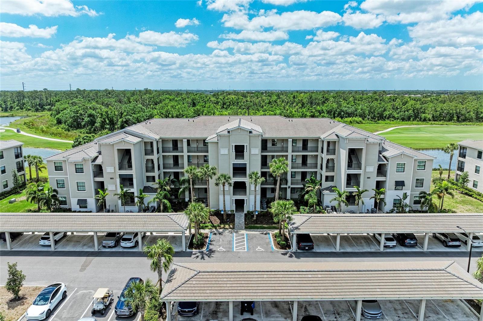 Start Living the Good Life in Lakewood National! Welcome to this beautiful TURNKEY-FURNISHED Birkdale condo, perfectly positioned on the 2nd floor with elevator access in the highly desirable Lakewood National Golf Club. Enjoy sweeping views of the golf course and tranquil pond from your private screened lanai in one of Lakewood Ranch’s premier golf inclusive communities. This light and bright 2-bedroom, 2-bath residence features one of the most popular and functional floorplans, offering an open-concept layout with split bedrooms for added privacy. The spacious kitchen boasts linen-painted cabinetry, quartz countertops, stainless steel appliances, and a large center island with breakfast bar—perfect for cooking, entertaining, or casual dining. The primary suite provides a serene retreat with a large walk-in closet and a luxurious en-suite bathroom featuring quartz counters and a glass-enclosed walk-in shower. A well-sized second bedroom, full guest bath, and interior laundry provides convenience and comfort for residents and visitors alike. An assigned carport and private storage closet are also included. ENJOY MEMBERSHIP AND UNLIMITED GOLF on 36 holes of championship Arnold Palmer-designed courses, along with access to world-class amenities including seven resort-style pools, eight Har-Tru tennis courts, four pickleball courts, a state-of-the-art fitness center, full-service spa, Tiki Bar, and an elegant clubhouse with fine dining. A full-time lifestyle director ensures a vibrant calendar of events year-round. Located within a 24-hour gated and security-patrolled community in the award-winning Lakewood Ranch, you’re just minutes from upscale shopping, fine dining, A+ rated schools, top medical facilities. With I-75, SRQ Airport, downtown Sarasota, and the pristine Gulf Coast beaches all easily accessible, you’ll be close to everything you need and love. Whether you’re a golfer, snowbird, full-time resident, or investor, this Birkdale condo delivers the perfect blend of luxury, lifestyle, and location—truly a piece of paradise!
