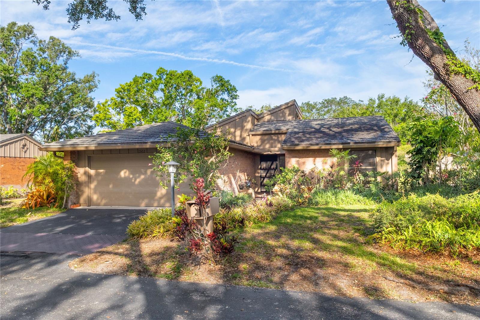 You will discover comfort, flexibility and natural beauty in this spacious 3 bedroom, 2 bath condo in the lushly landscaped Oaks community with yard care and community pool/spa. The versatile floorplan offers multiple layout options, just bring your imagination and make it your own! The central kitchen has custom cabinets, volume ceilings, newer appliances and opens to a private side patio for relaxing or grilling. The living room boasts custom built-ins and vaulted ceilings with clerestory windows that flood the space with natural light. The oversized family room offers a decorative fireplace and expansive windows showcasing serene backyard views. A separate den provides an additional fireplace and sliding French doors that lead to a private patio with tranquil pond views. The generous ensuite primary bedroom is large enough for a sitting area, enormous walk-in closet and dedicated laundry room. The seller installed a seawall to the rear of the house to prevent any erosion into the pond. Both the interior and exterior have recently been repainted.