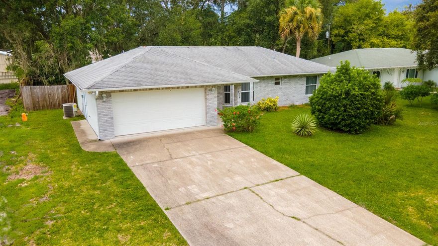 SELLER SAYS BRING OFFERS!!  Solid construction home built in 2005 with storm grade garage door, metal corrugated shutters for windows, brick facing, and block exterior.  Welcome home to this contemporary styled 3/2 ranch home on the northern side of Florida Shores.  Vaulted ceilings and an open floor plan greet you upon entry with the kitchen bar bordering the living room it is the perfect place to congregate, entertain, relax, and live.  The split bedrooms allow the separation of space and sanity desired by today's buyers.  From the dining room, out of the french doors is an inviting patio and huge back yard giving you a flexibility of space and uses.  Lots to offer - come and see for your self! ;Water: City