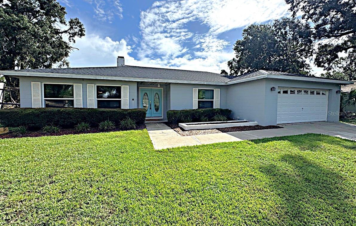 One or more photo(s) has been virtually staged. Located in the desirable Imperial Lakes neighborhood, this home offers convenient access to all that Mulberry and South Lakeland have to offer. The living room showcases a large decorative brick fireplace and French doors that fill the space with natural light. The recently remodeled kitchen features stainless steel appliances, granite countertops, and a counter-height bar that opens to the living area, creating a perfect space for both everyday living and entertaining. A formal dining room is located off the kitchen and connects to a second living room, offering flexibility and comfort. The two guest bedrooms have been updated with new carpet, while the primary bedroom features tile flooring, an en suite bathroom, and a walk-in closet with fresh carpeting. The laundry area, with washer and dryer hookups, is located in the garage. Outside, enjoy the privacy of no rear neighbors and a tranquil view from your fully fenced backyard. A spacious screened-in porch provides the ideal spot for relaxing or entertaining. Additional features include a two-car attached garage and a wide driveway, ensuring plenty of parking.