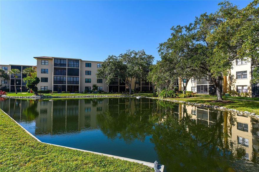 Welcome Home to this lovely, well-maintained first floor condo in 55+ community of Wood Park at Desoto Square in Bradenton! A stunning tropical oasis, Wood Park is a gated serene retreat with lush tropical landscaping and resort style amenities in the heart of central Bradenton. This first-floor residence is clean and bright, with a split bedroom plan and open concept living and dining spaces. The kitchen is fully equipped and features tons of storage in warm, wood-look cabinets and a cozy breakfast nook with open shelves.  The secondary bedroom just off the entrance has its own bath and easy access to the stacked in-unit LAUNDRY closet!  The living/dining rooms have gorgeous tile flooring and flow out to the screen enclosed balcony with storm windows and a breathtaking view of the pond, fountain, and mature tropical foliage.  The primary suite is spacious and features a walk-in closet, and an en-suite bathroom with a tiled walk-in shower.  This home is fully furnished and move-in ready so that you can start enjoying the Florida lifestyle you’ve imagined!  Spend days cooling off at the community pool, have picnics by the lake, play shuffleboard on the grounds surrounded by gorgeous tropical trees and flowers, or join neighbors in the clubhouse for a workout or a game of pool.  Anna Maria Island is just minutes away, and it's convenient to downtown Bradenton’s nightlife, Riverwalk and the new River Taxi to Anna Maria Island.  LeCom Park is nearby for Bradenton Marauders games and Pittsburg Pirates spring training too!  Call today to schedule your showing!