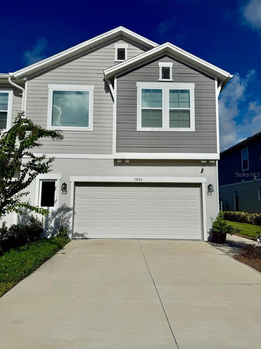 Welcome to Meadow Ridge, a peaceful and conveniently located neighborhood in the heart of Ocoee, just minutes from downtown Winter Garden, top-rated schools, and major highways including FL-429 and the Turnpike. Nestled within Lake Meadow Landing, 1856 Terrapin Rd stands out as the largest two-story corner unit townhome in the community. This spacious residence features a modern open floor plan with laminate flooring throughout the first floor, a full bathroom, and a versatile bedroom that can serve as a guest room or home office. The kitchen is equipped with quartz countertops, 42” cabinets with crown molding, and stainless steel appliances, flowing seamlessly into the living and dining areas. Sliding glass doors lead to a private outdoor space with serene views of Lake Meadow. Upstairs, the owner's suite offers a generous layout and stunning lake views perfect for enjoying Florida sunsets. A large loft provides flexible living space, ideal for a second living area or media room. Two additional bedrooms, two full bathrooms, a dedicated laundry room, and ample closet space complete the upper level. Designed for everyday comfort and modern living, this home blends style, functionality, and a tranquil setting—making it an exceptional opportunity in a desirable community.