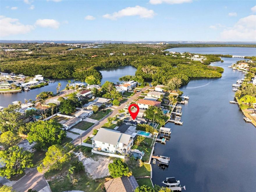 One or more photo(s) has been virtually staged. Tropical breeze and palms trees welcome you to this stunning waterfront property in desirable Riviera Bay! This home offers the perfect blend of coastal lifestyle and everyday convenience in Gateway. A WIDE saltwater canal with SALTWATER POOL, private covered BOAT LIFT, dock, and easy access to the open waters of Tampa Bay! Get ready to live the DREAM -- where every day feels like vacation, dolphins, manatees and pelicans are your backyard neighbors! This solid home is a blank slate--ready for you to bring your vision to life! Home is offered in "cut drywall" conditional at LAND VALUE for seller convenience, this large lot is perfect for either building your new construction dream home, elevating the existing structure or remodeling existing. This 3/2/1 block home has WHOLE HOUSE SOLAR (paid off), a SALTWATER POOL, beatable access to sandbar Sundays and sunset cruises. The well-designed split floor plan enhances privacy while maintaining a comfortable and functional flow between living spaces. This home was truly made for entertaining friends and family! 
The primary suite provides the space for your vision of your own peaceful retreat with calming water views, spacious walk-in closet, and private bath. 
Outside, the property transforms into a private waterfront escape featuring a saltwater pool overlooking the Intracoastal waters, only one bridge giving ample possibilities for your boat selection. The location also provides front row views of the annual Christmas Boat Parade from your backyard--talk about hosting the best shindig of the year! 
The backyard is generously sized, complete with pergola, paver patio ideal for entertaining, dining, or relaxing outdoors throughout the year. A circular driveway offers easy access and additional parking, along with an attached garage suitable for storage or workspace.
Outdoor enthusiasts will appreciate the close proximity to Weedon Island Preserve, known for its kayaking trails, boardwalks, and preserved natural landscapes.
Conveniently positioned between St. Petersburg, Clearwater, and Tampa, this property provides quick access to award winning Gulf beaches, Tampa International Airport, dining, entertainment, state of the art St Pete Pier, Dali Museum, Central Ave, Arts District, Publix, Target, Homegoods and so much more. 
This is your chance to secure a truly special coastal property at an incredible value while you still can! Schedule your tour today.