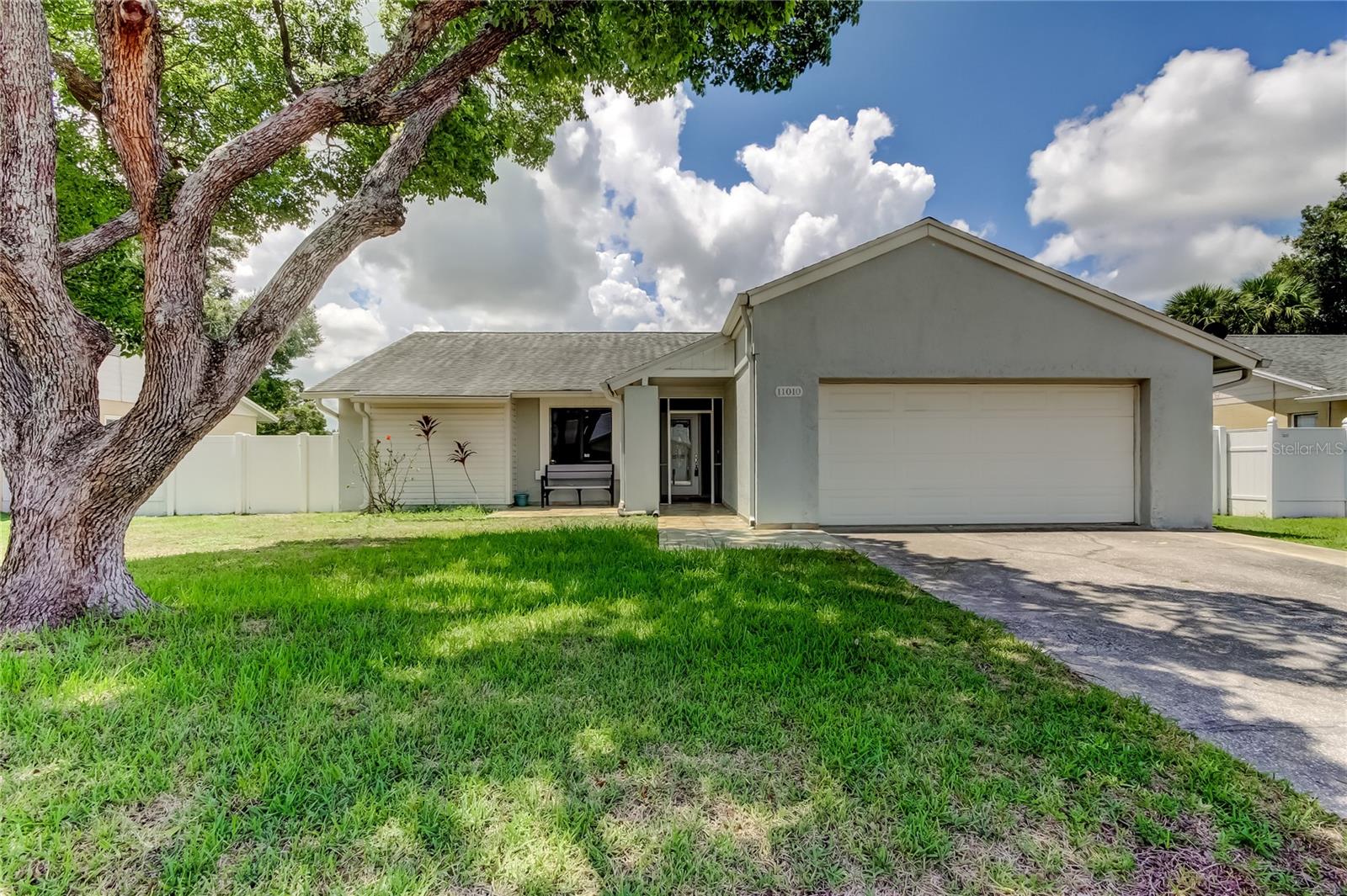 BEAUTIFUL 3/2/2 Home in the Heart of Carrollwood! LOW HOA, No CDD's , No Flood zone !! This spacious property offers over 1,416 square feet of comfortable living in one of Tampa’s best locations. Step inside and be greeted by vaulted ceilings that create an open, airy feel, complemented by elegant Ceramic tile flooring in the main areas and laminate wood floors in the bedrooms. ROOF 2019, A/C 2022, WaterHeater 2022. The kitchen and bathrooms feature granite countertops, sleek fixtures, and modern updates, while the kitchen boasts matching appliances perfect for everyday living. Crown molding, ceiling fans throughout, and an updated bath add a touch of style and convenience. Enjoy the oversized two-car garage, a dedicated laundry area with washer and dryer, and charming French doors leading to a covered patio, ideal for relaxing or entertaining. The fully fenced backyard with PVC fencing offers privacy and security and a very low maintenance yard with a rock garden. The home also offers a water softener system. Located in a vibrant Carrollwood community, residents have access to pools, tennis courts, basketball courts, walking trails, and more. Just minutes from Gunn Highway, Linebaugh Avenue, Dale Mabry, the Veterans Expressway, and surrounded by shopping, dining, schools, and banks, this home places you in the center of everything. Don’t miss the opportunity to own this well-maintained property in a prime location!