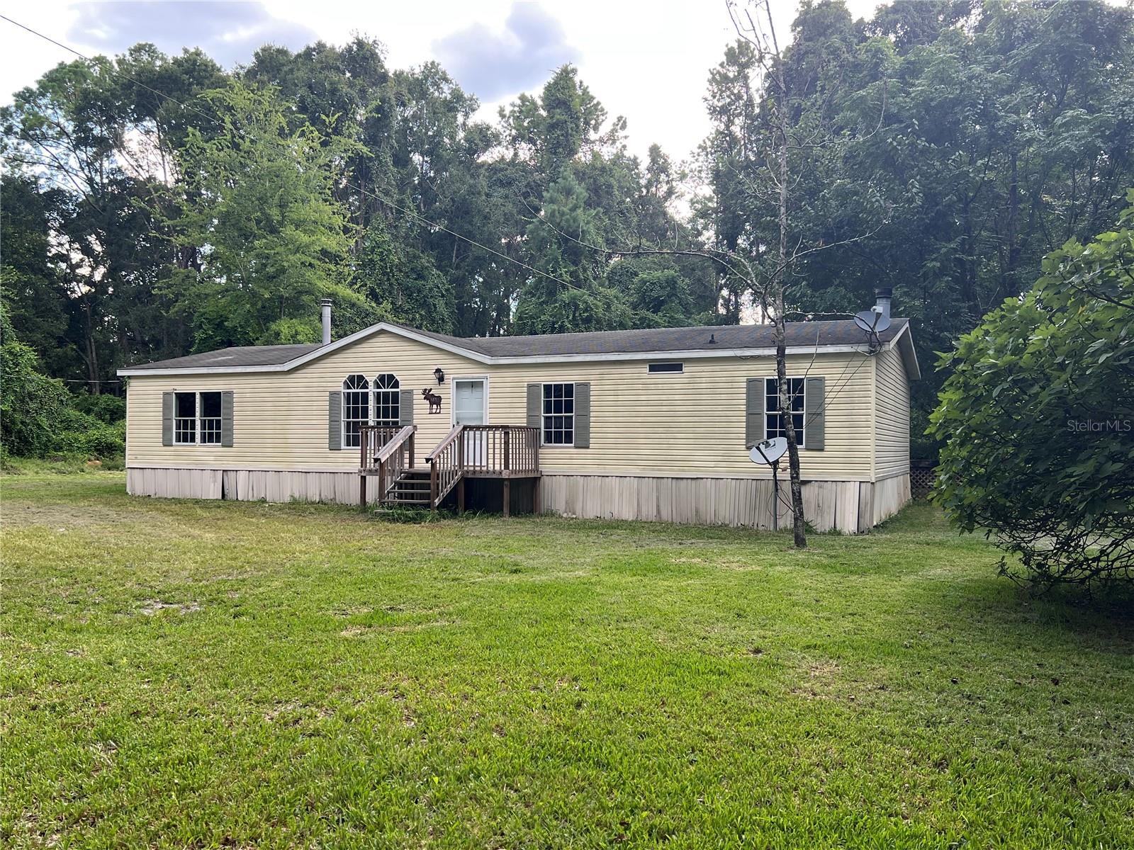 This split floor plan provides ample open space with a living room, dining room, and family room all connected. New refrigerator, range, dishwasher, and microwave installed 2025. New flooring installed in living spaces and bedrooms, new water heater installed in 2023, new AC system installed in 2022. Laundry closet off of kitchen. Enjoy over 5 acres of land tucked away in the back of the Oak Ridge Forest subdivision which a short drive from several springs, including O’Leno State Park just around the corner.